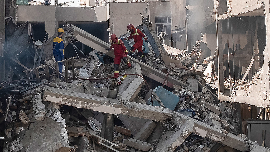 Iranian rescue teams search for survivors following Israeli airstrikes in Tehran, Iran, on June 14, 2025. /VCG