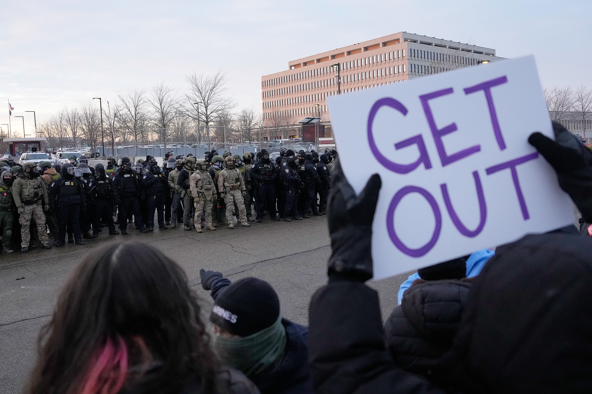 A protester holds a sign reading 