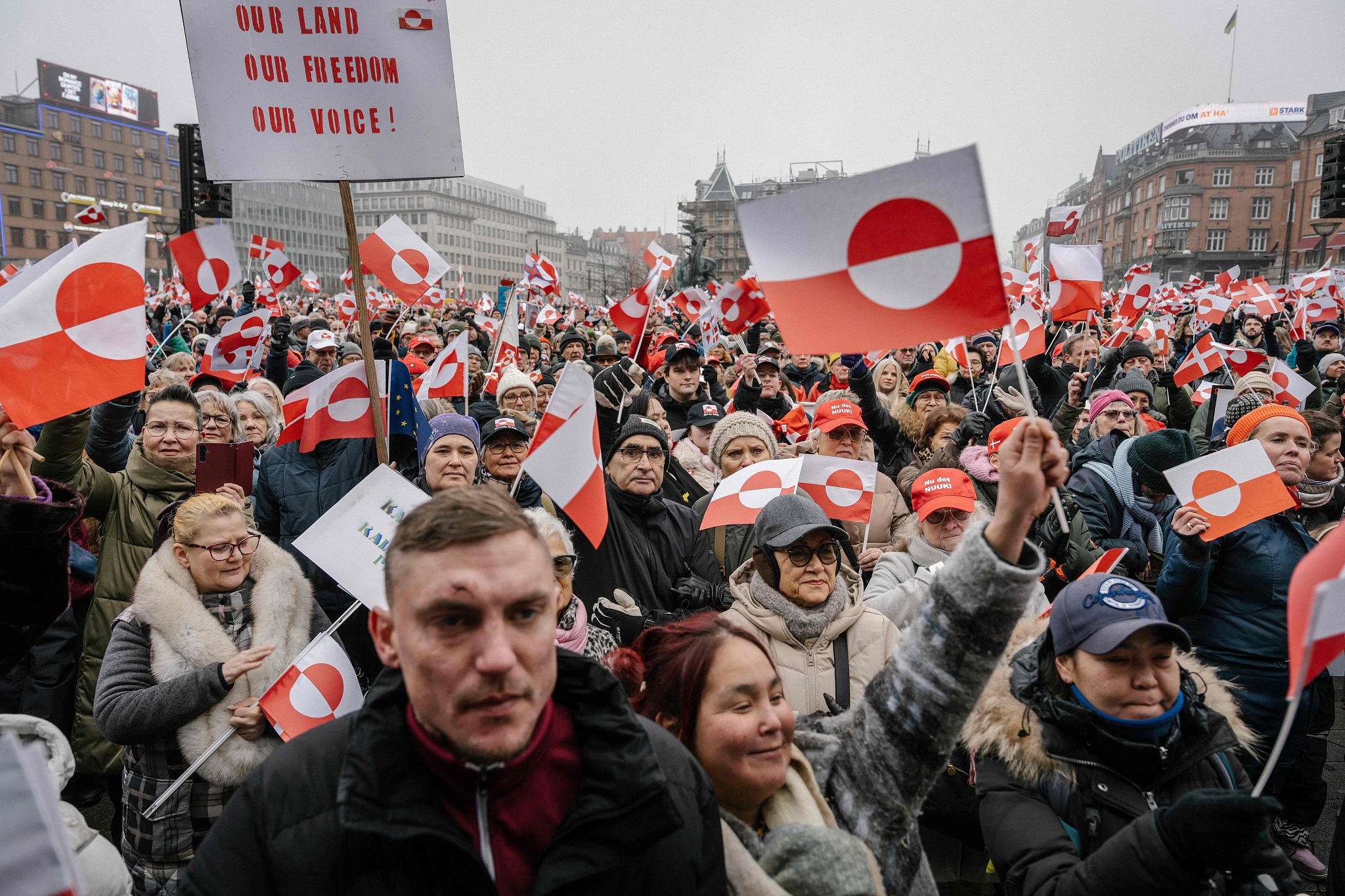 Protesters wave Greenlandic flags as they take part in a rally under the slogans 