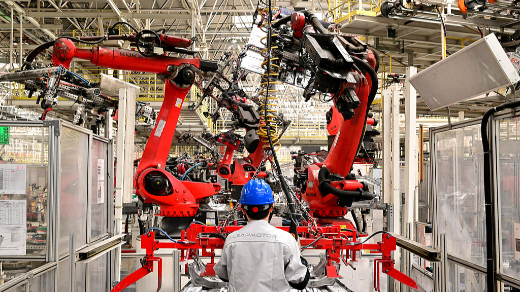 Workers assemble components on an automated new energy vehicle production line in Jinhua City, eastern China's Zhejiang Province, May 13, 2025. /VCG