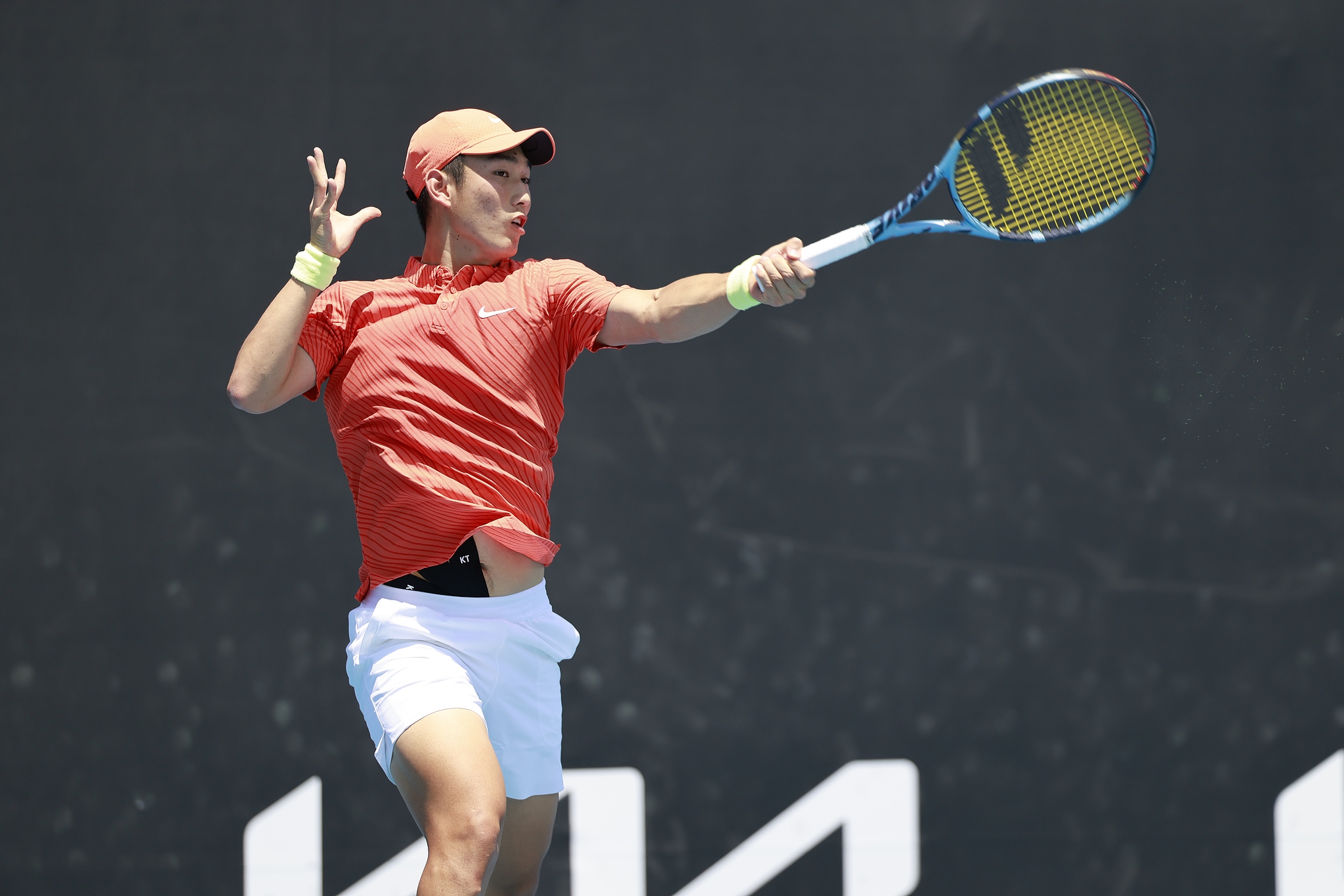 China's Shang Juncheng hits a shot in the men's singles first-round match against Spain's Roberto Bautista-Agut at the Australian Open at Melbourne Park in Melbourne, Australia, January 19, 2026. /VCG