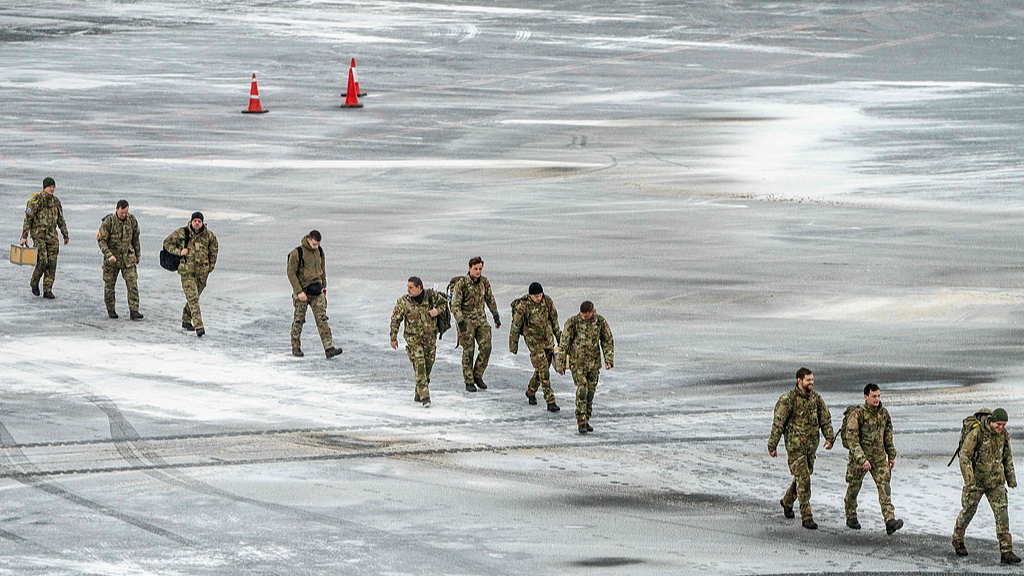 Danish soldiers walk across the frozen tarmac after arriving at Nuuk Airport, Greenland, January 19, 2026. /VCG