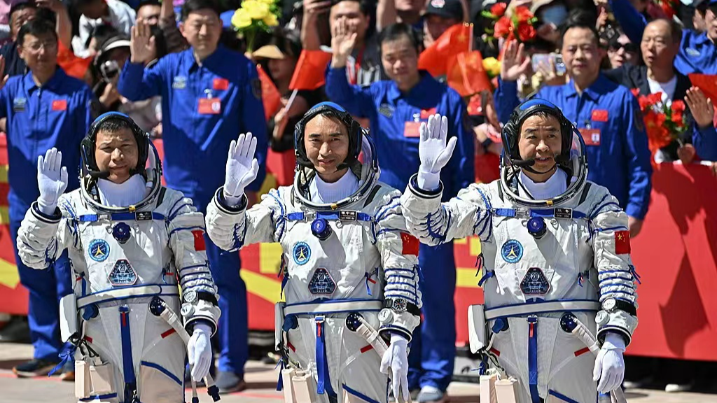 Astronauts from China's Shenzhou-20 space mission wave during a departure ceremony before boarding the Shenzhou-20 spaceship on April 24, 2025. /VCG