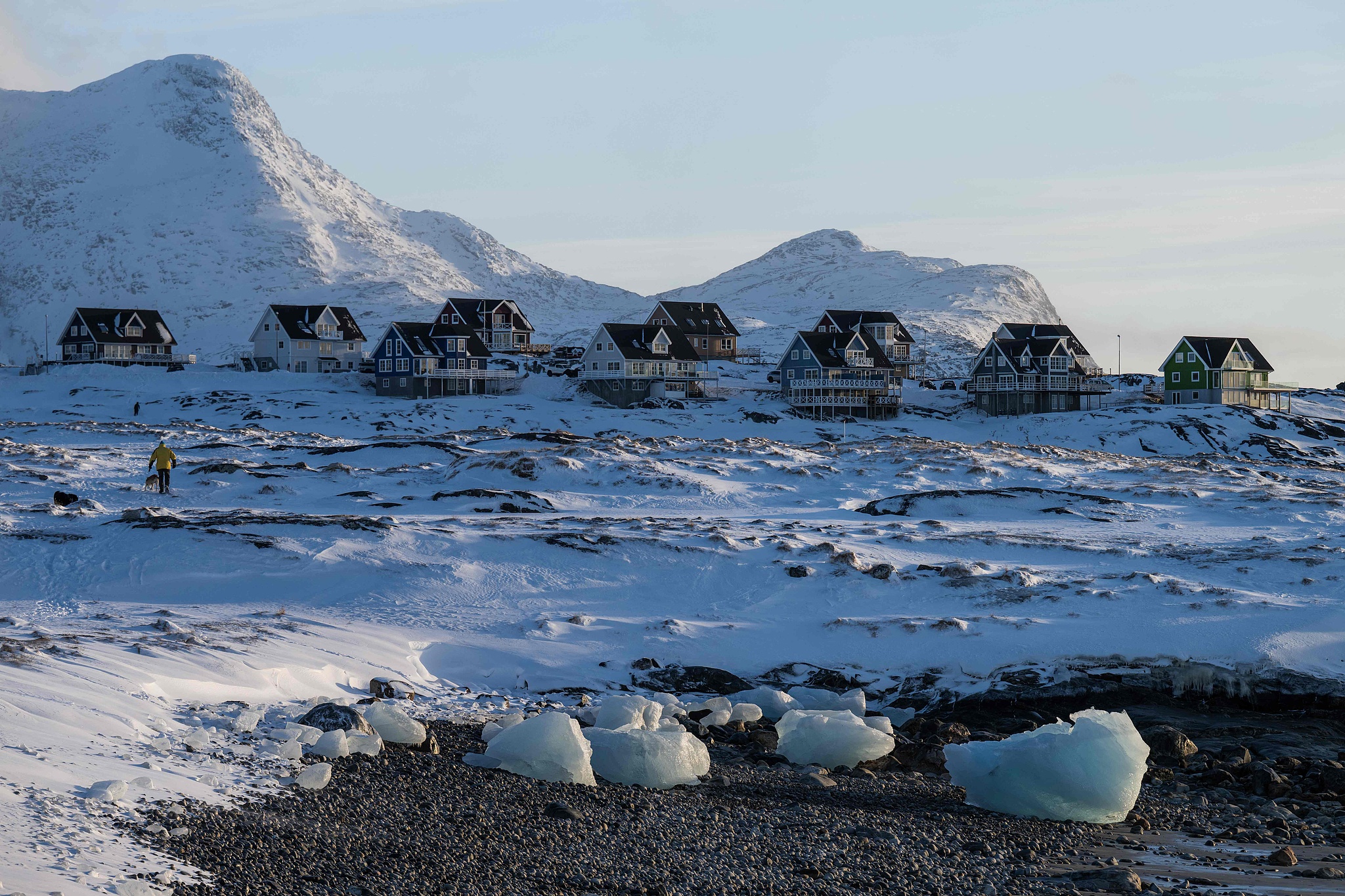 Houses are pictured along the coastline with snow-covered mountains in Greenland, Jan. 20, 2026. /VCG