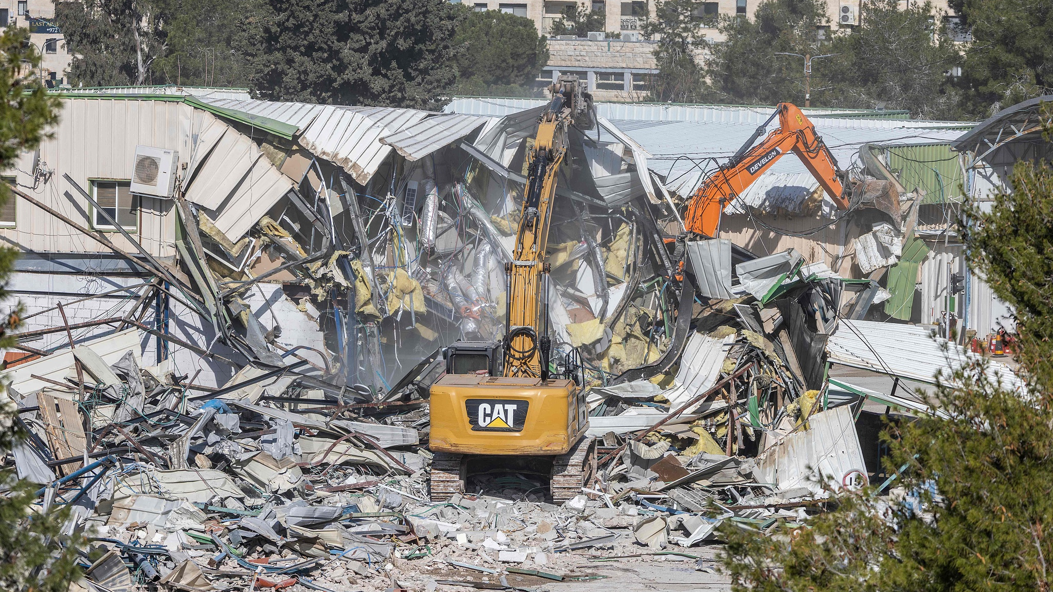 Machinery demolishes a structure inside the headquarters of the UNRWA in East Jerusalem, January 20, 2026. /VCG