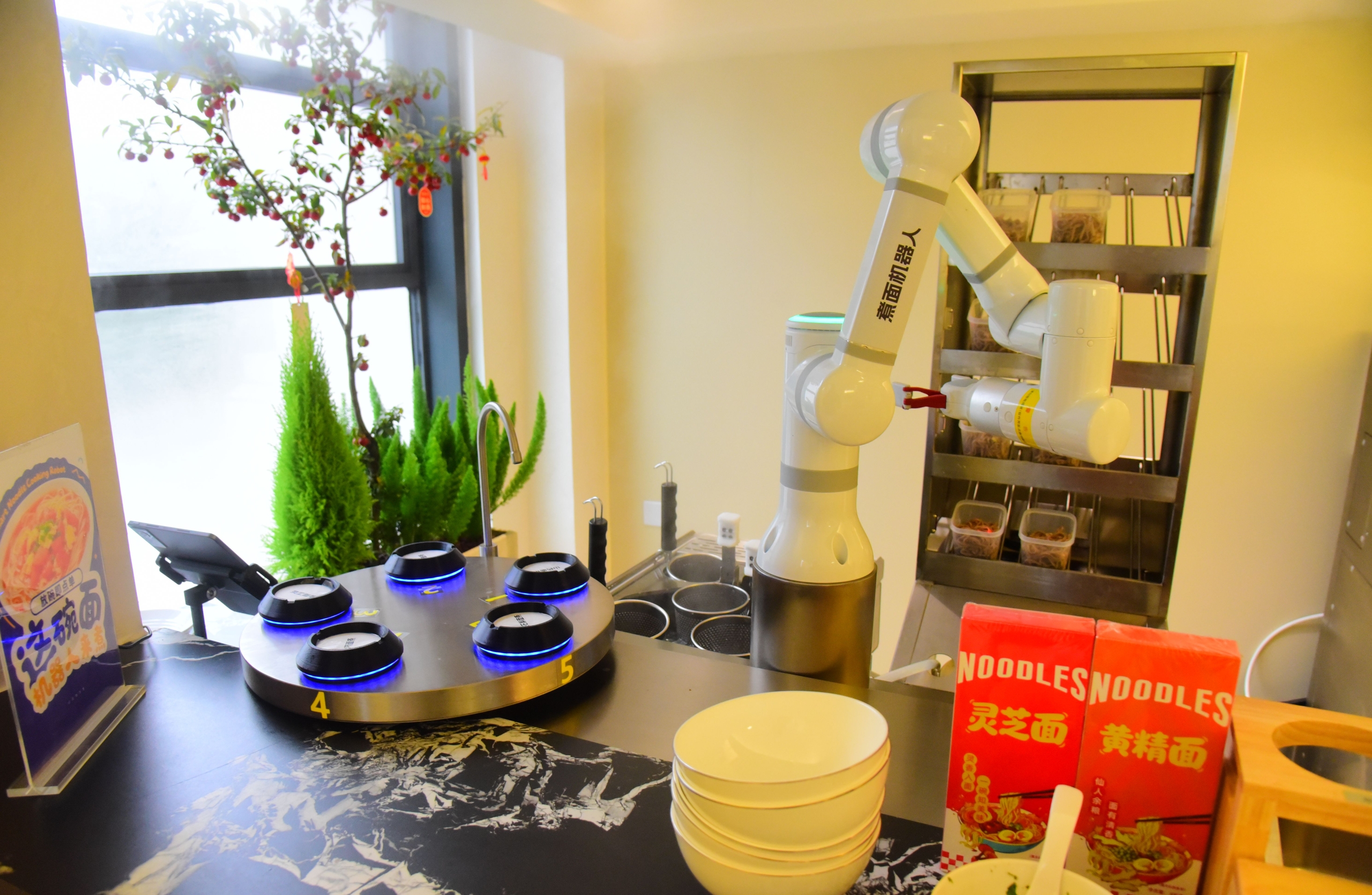 A noodle-cooking robot operates in an AI robot restaurant in Hangzhou, Zhejiang Province, on January 20, 2026. /IC