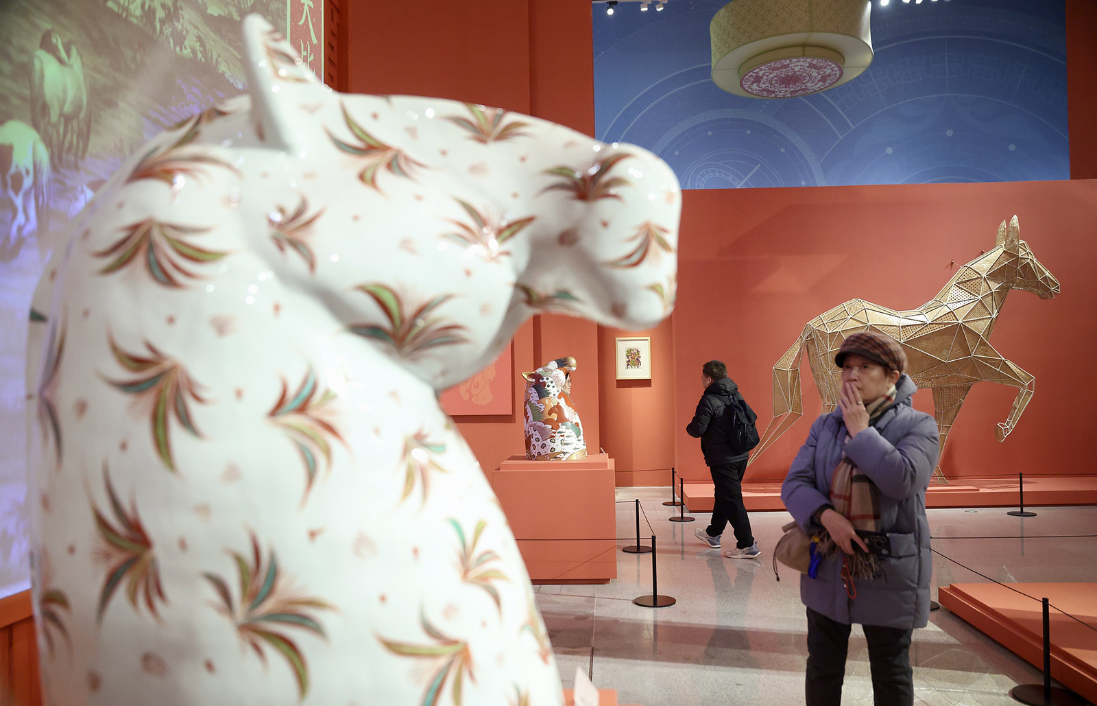 Visitors admire horse-themed ceramic artworks at a Spring Festival-themed exhibition at the Chinese Traditional Culture Museum in Beijing on January 20, 2026. /Yi Haifei, China News Service via VCG