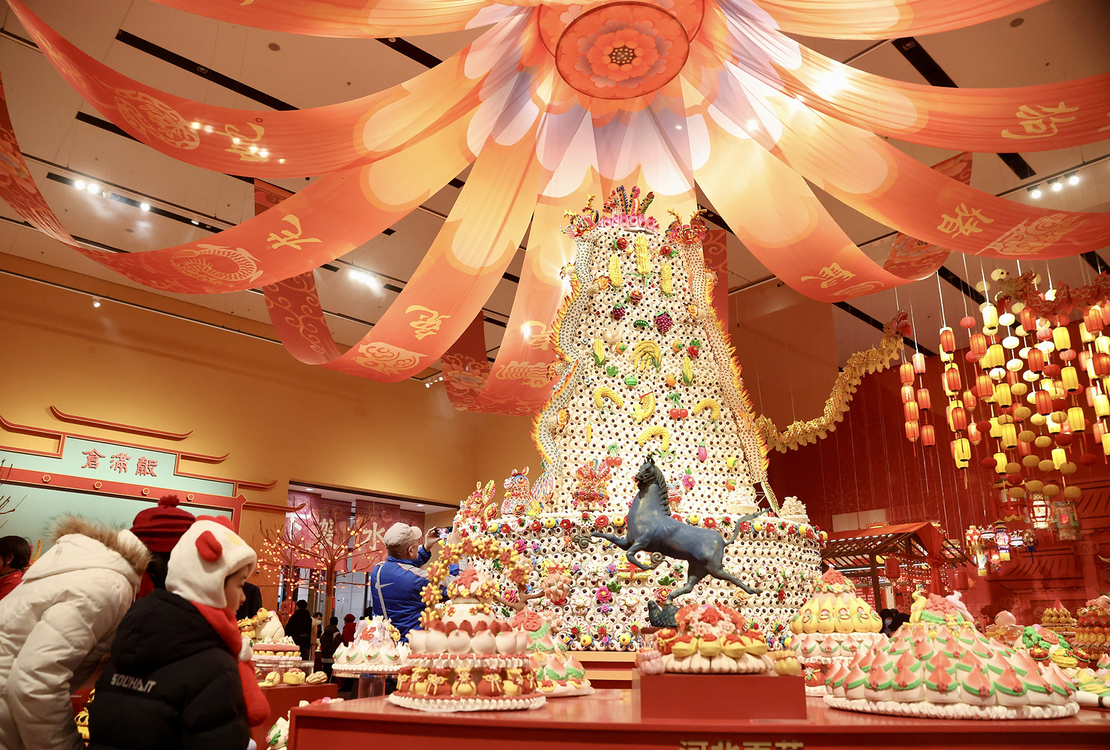 A giant intangible cultural heritage dough figurine from Shaanxi Province is seen on display at a Spring Festival-themed exhibition at the Chinese Traditional Culture Museum in Beijing on January 20, 2026. The 4.5-meter-tall, 3.6-meter-diameter artwork took 18 artisans one month to complete. /Yi Haifei, China News Service via VCG