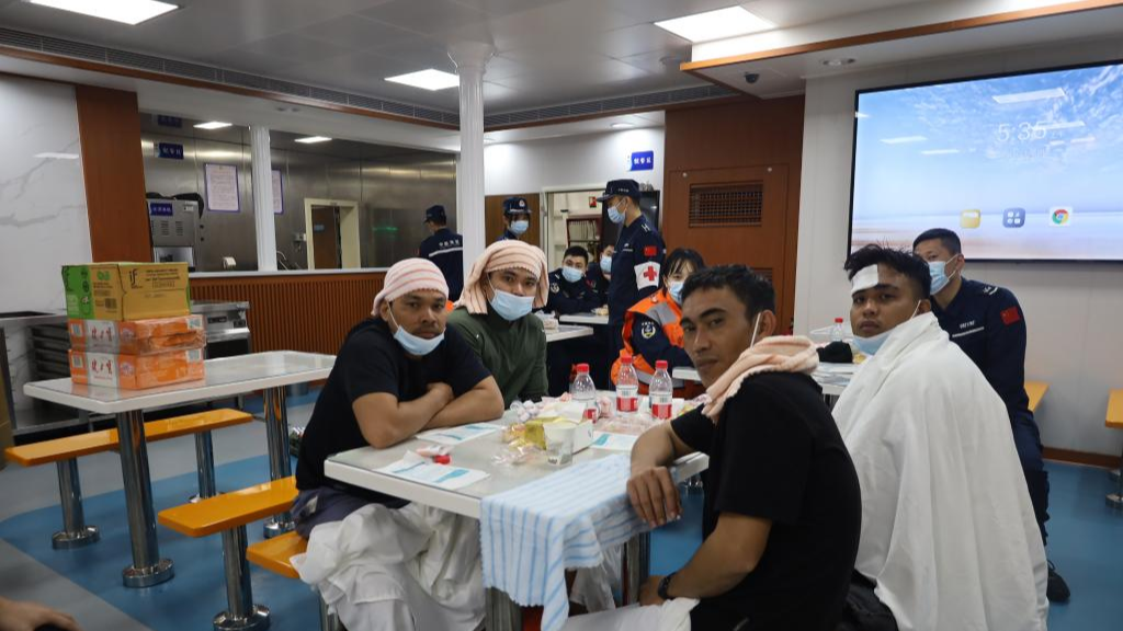 Rescued Filipino crew members pictured after a foreign cargo ship capsized in the territorial waters of south China's Huangyan Dao, January 23, 2026. /China Coast Guard