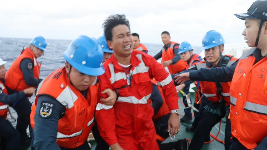 Members of the China Coast Guard rescue a Filipino crew member after a foreign cargo ship capsized in the territorial waters of south China's Huangyan Dao, January 23, 2026. /China Coast Guard