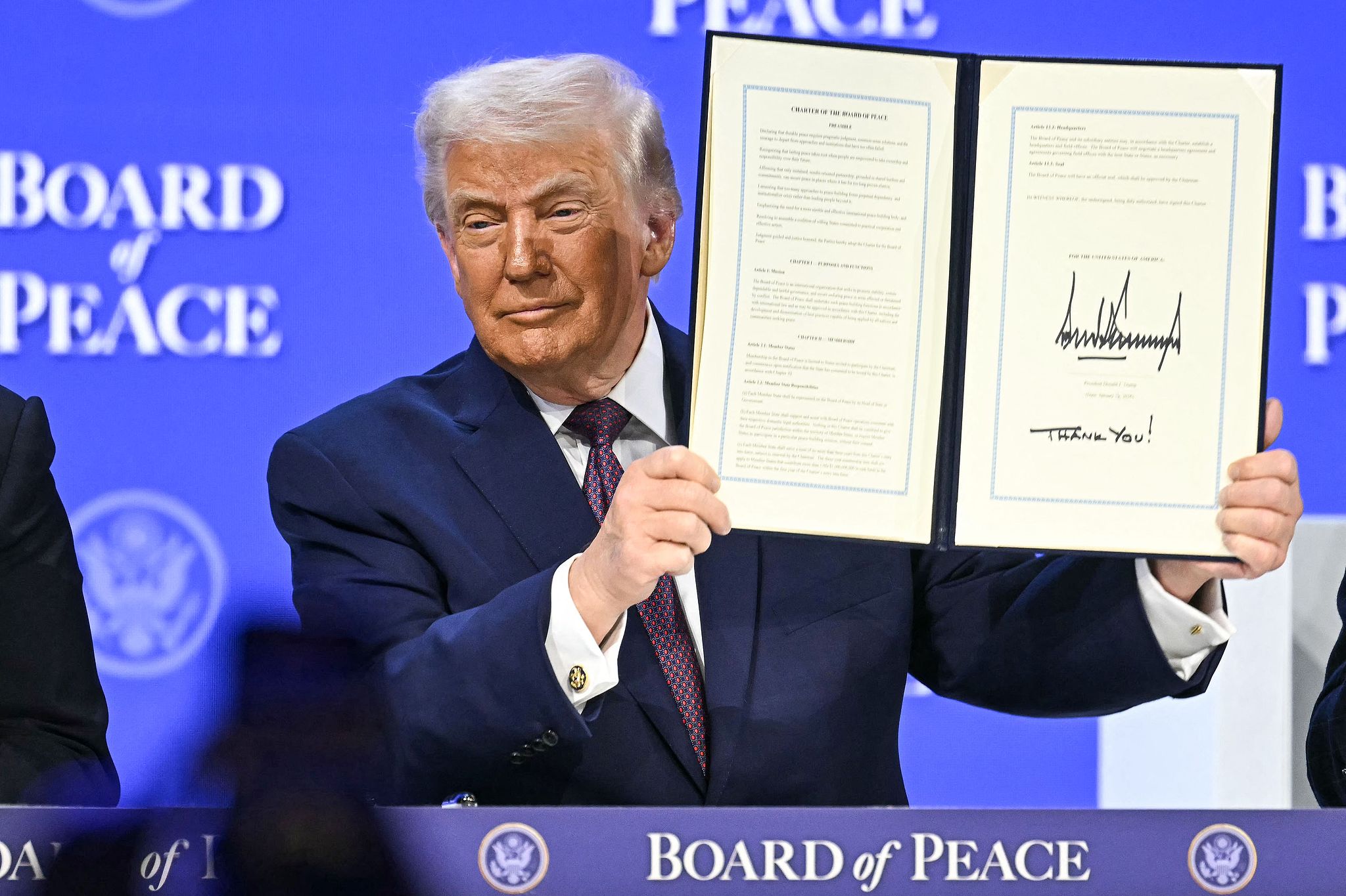 US President Donald Trump holds a signed founding charter at the 