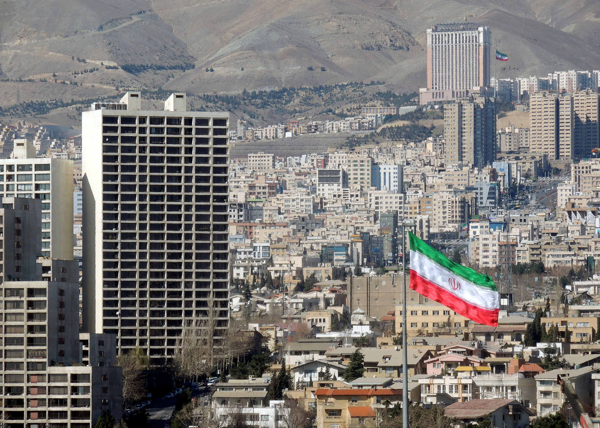Tehran skyline with Iranian flag. Tehran, Iran. /VCG