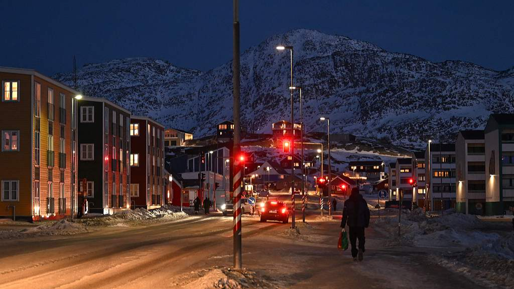 A man walks on a street past apartment buildings in Nuuk, Greenland, January 25, 2026. /VCG