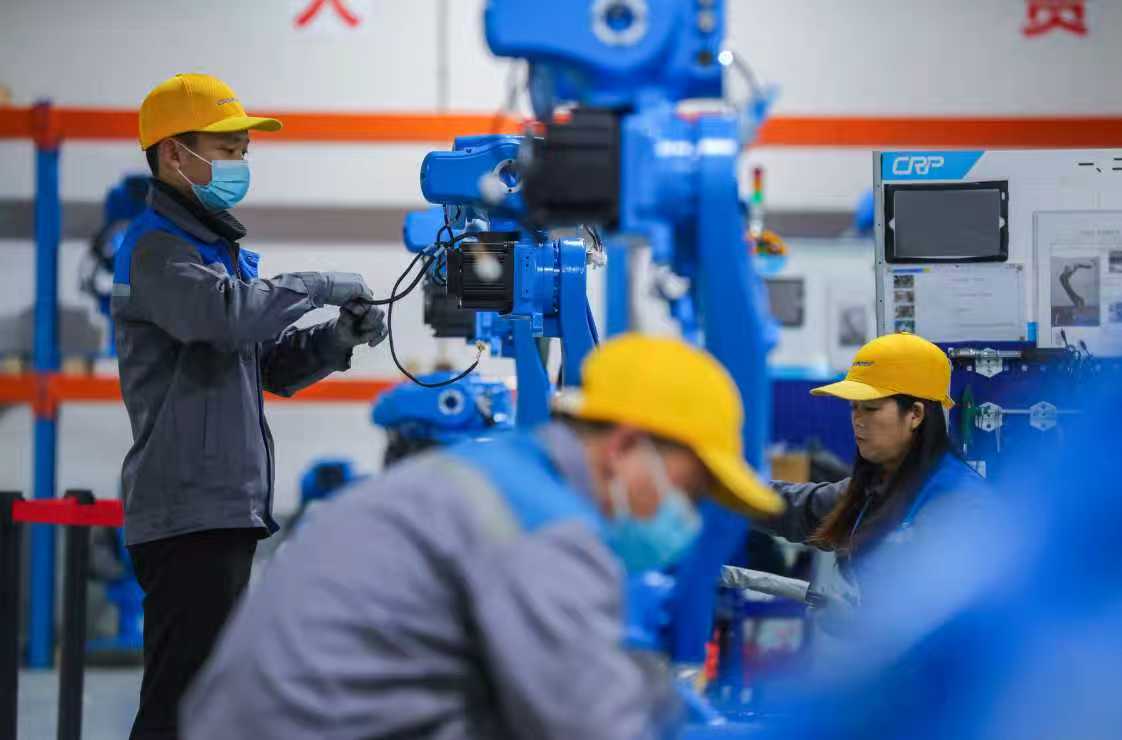 Workers assemble robotic arms in Sichuan, January 14, 2026. /CGTN