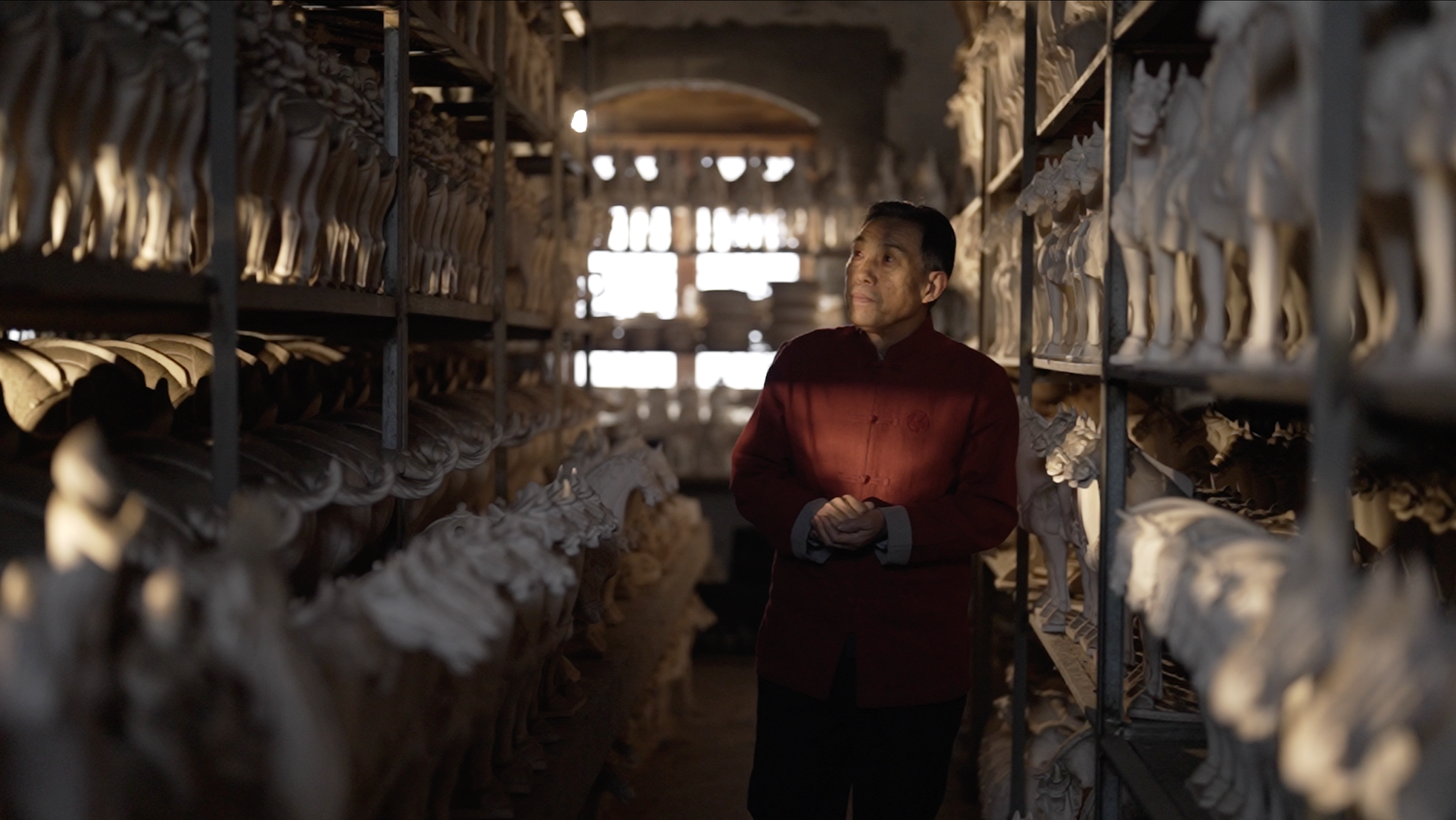Gao Shuiwang, inheritor of Tang Sancai pottery firing technique, checks the molds in his warehouse. /CGTN