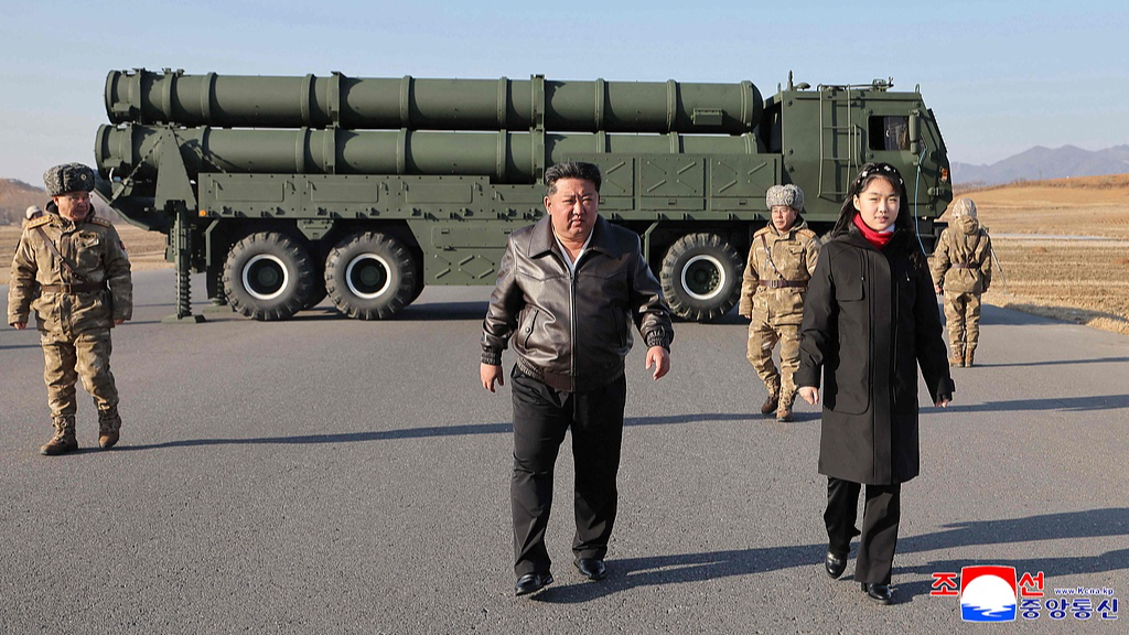 DPRK's top leader Kim Jong Un (C) and his daughter Kim Ju Ae (R) inspect a test firing of the renewed large-caliber rocket launcher system, in DPRK, January 27, 2026. /KCNA