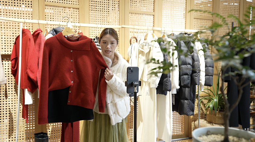 A livestreamer selling clothes at E-Fashion Town in Hangzhou, Zhejiang Province, China. /CGTN