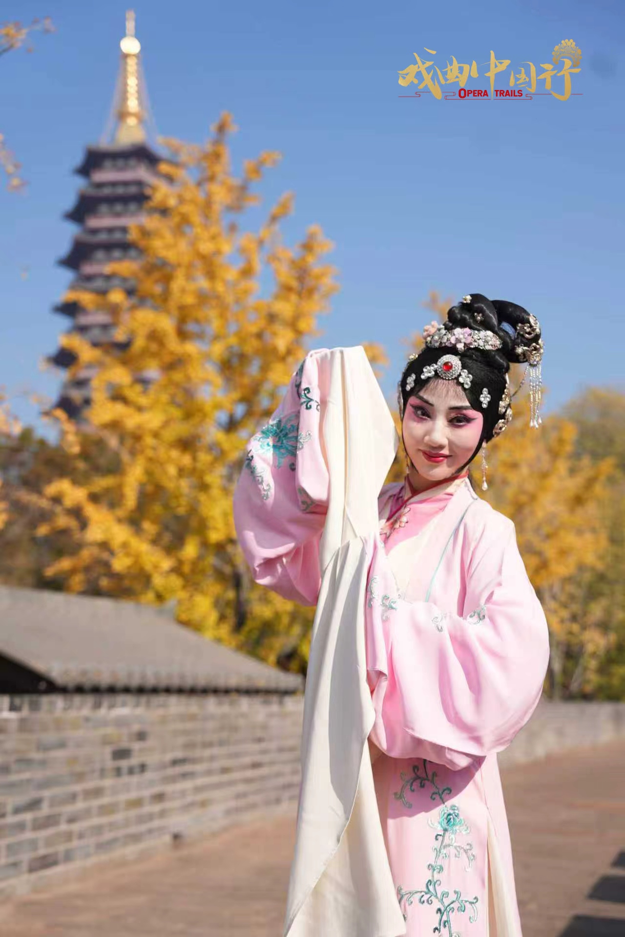 Wu Opera actress Lou Yiting stands against the Wanfo Pagoda in Jinhua City, east China's Zhejiang Province. /CGTN