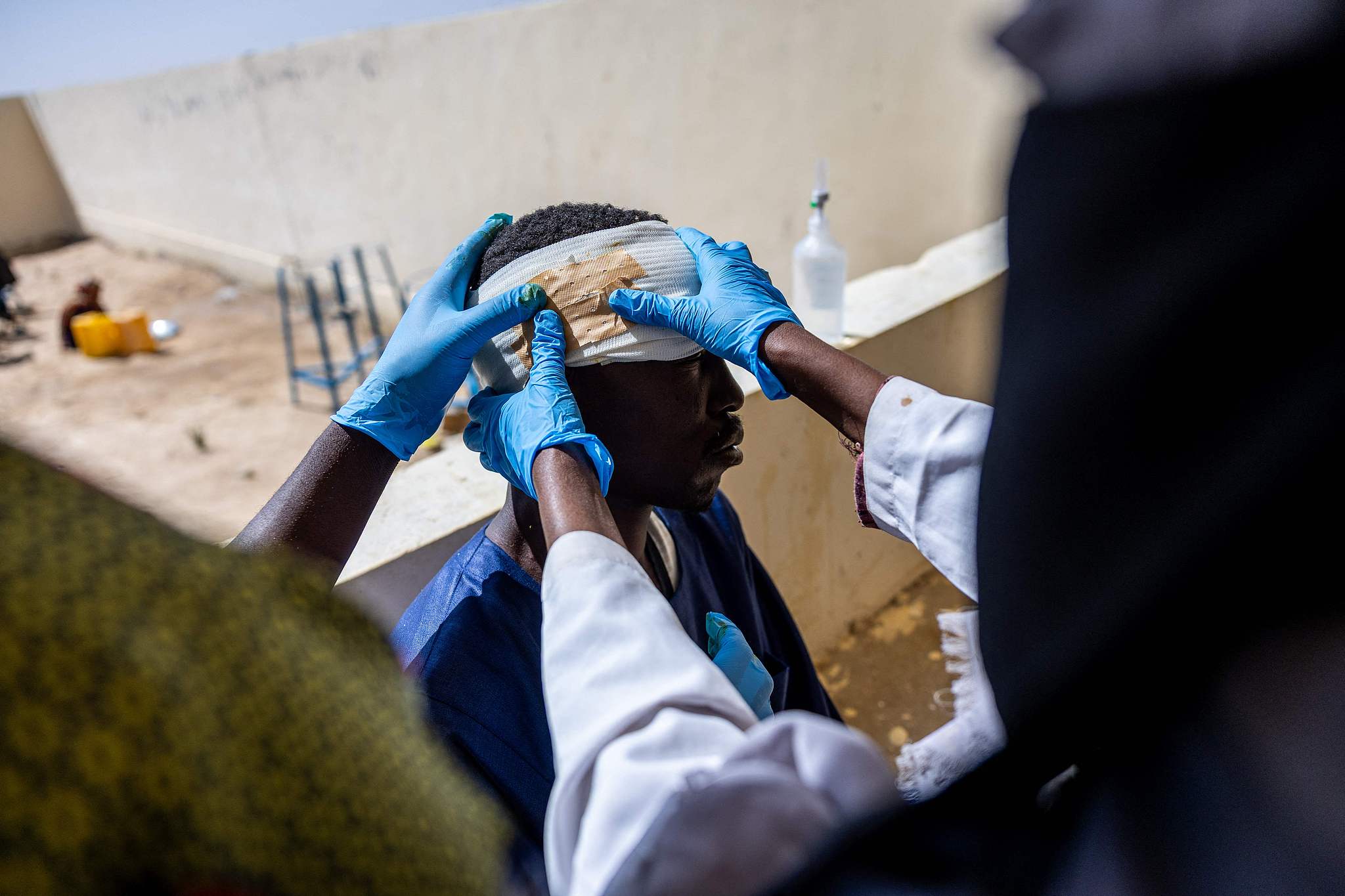 Mahamat Hamid Abakar, 33, who suffered head and leg injuries during a drone attack on the vehicle he was traveling in near Um Baru, Sudan, is being treated by nurses at a hospital in Tine, Wadi Fira, Chad, January 30, 2026. /VCG