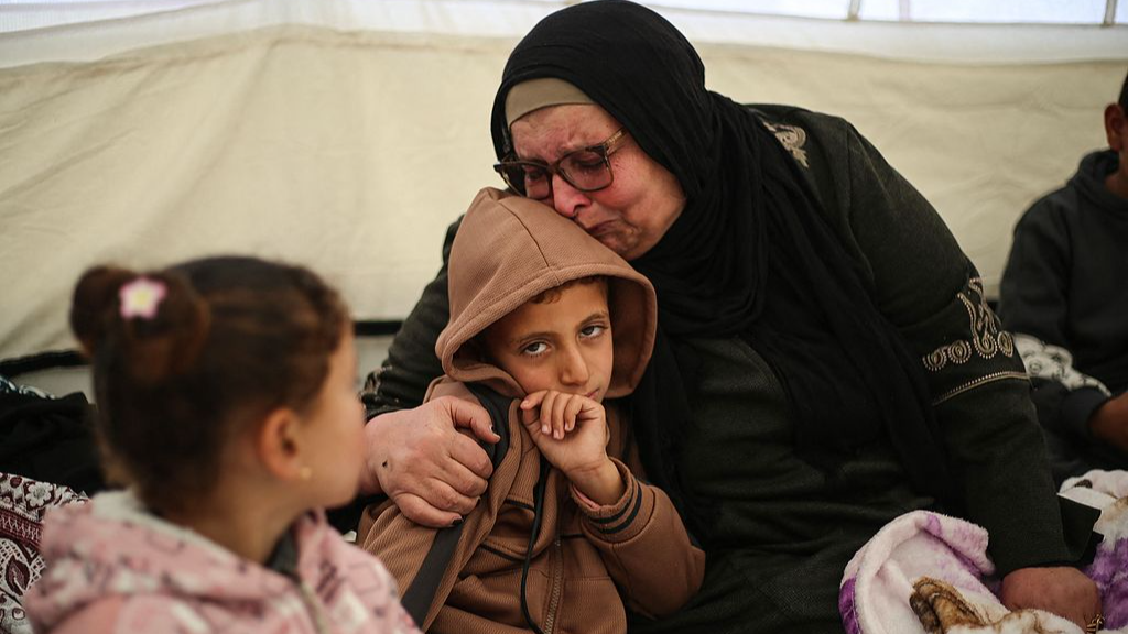 Palestinian Huda Abu Abed sits with her family in Khan Yunis, in the southern Gaza Strip, after returning from Egypt via the Rafah crossing, February 3, 2026. /VCG