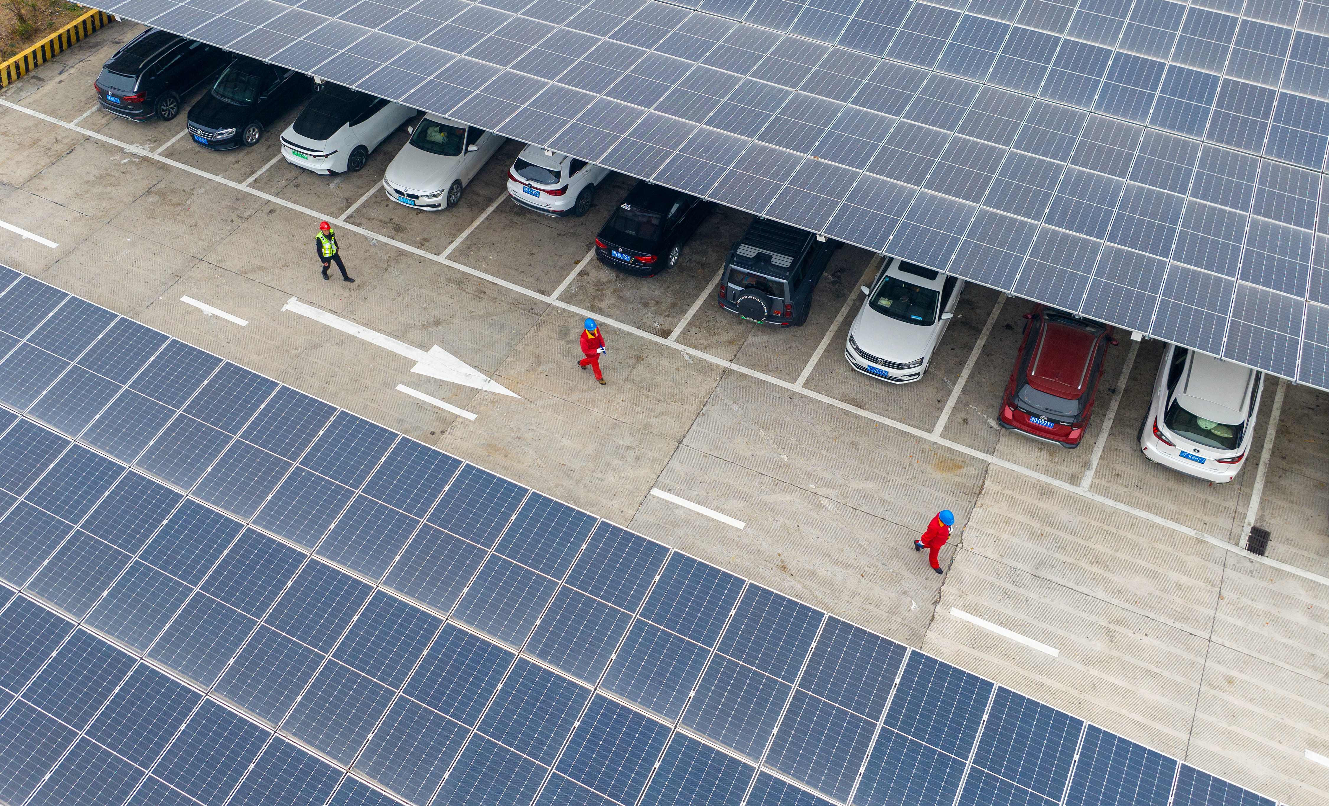 Workers carry out safety checks on charging facilities in a service area in Huzhou, east China's Zhejiang Province, February 1, 2025. /VCG