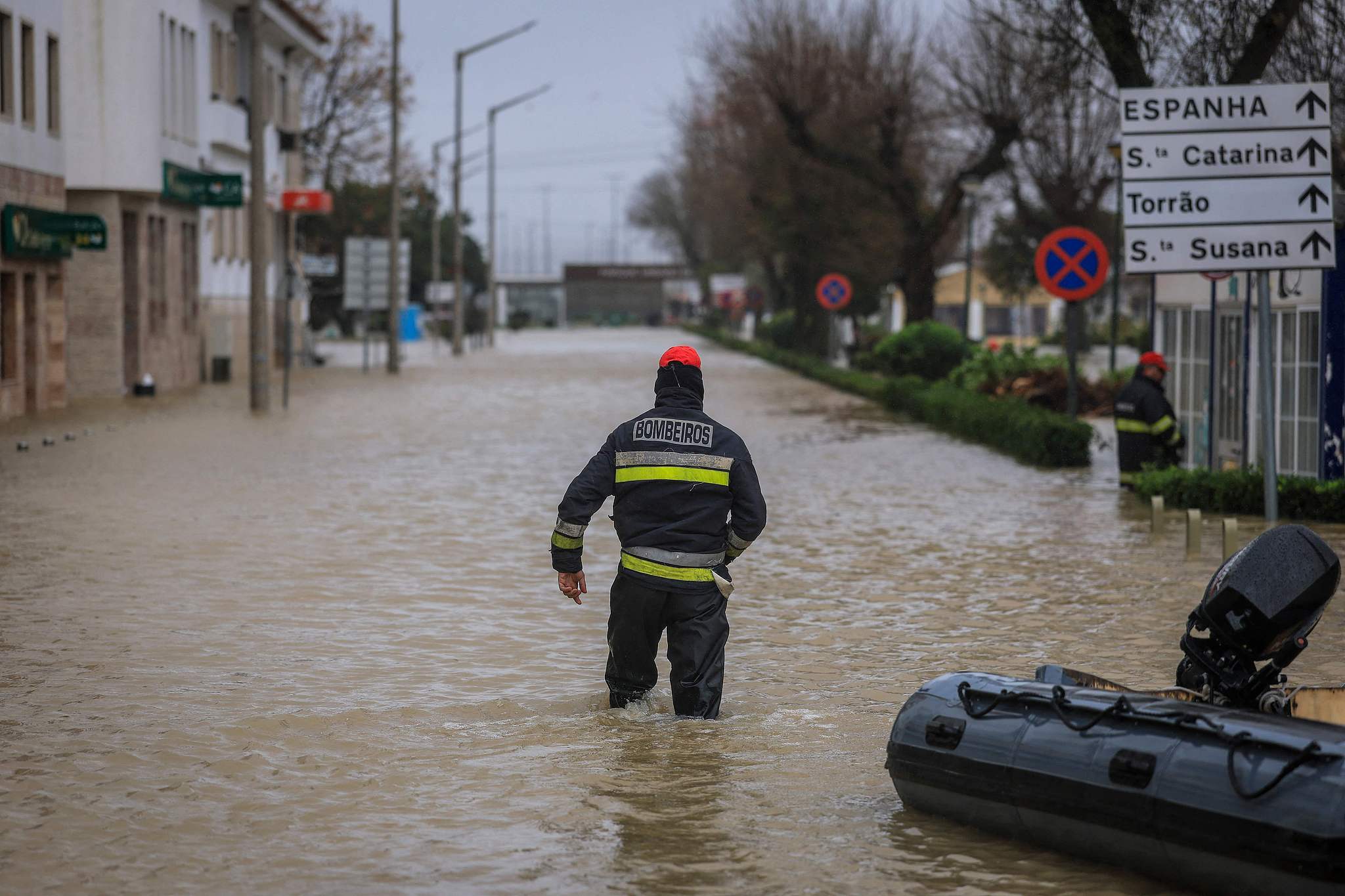 A firefighter walks in a flooded street of Alcacer do Sal, south of Portugal, during Leonardo storm on February 4, 2026. /VCG