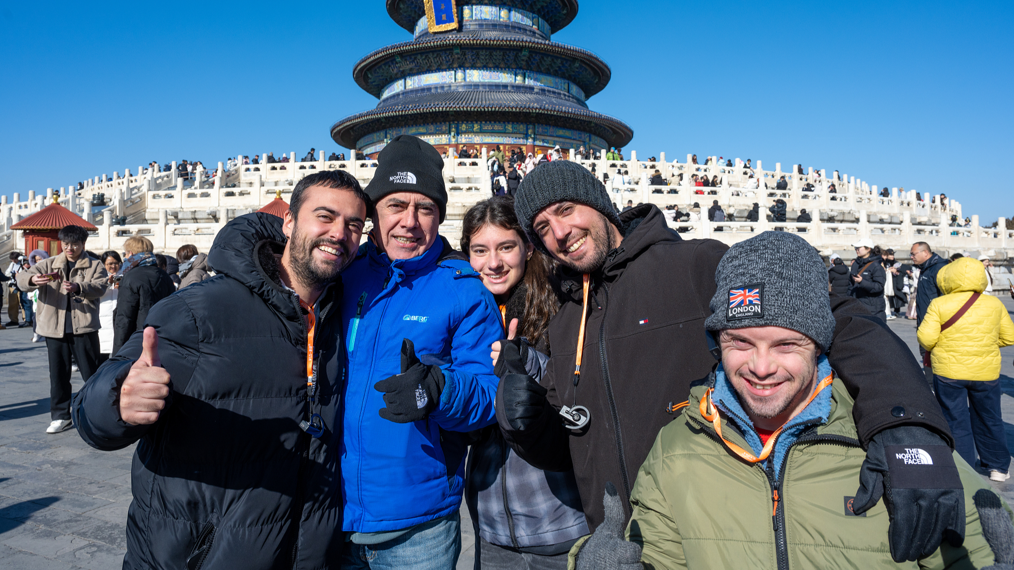 Foreign visitors pose for a group photo at a tourist spot in Beijing, China, January 31, 2026. /VCG