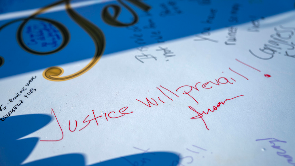 People sign a 10-foot art installation depicting a birthday card Jeffrey Epstein received on his 50th birthday in the early 2000s on the National Mall in Washington, D.C., January 20, 2026. /VCG