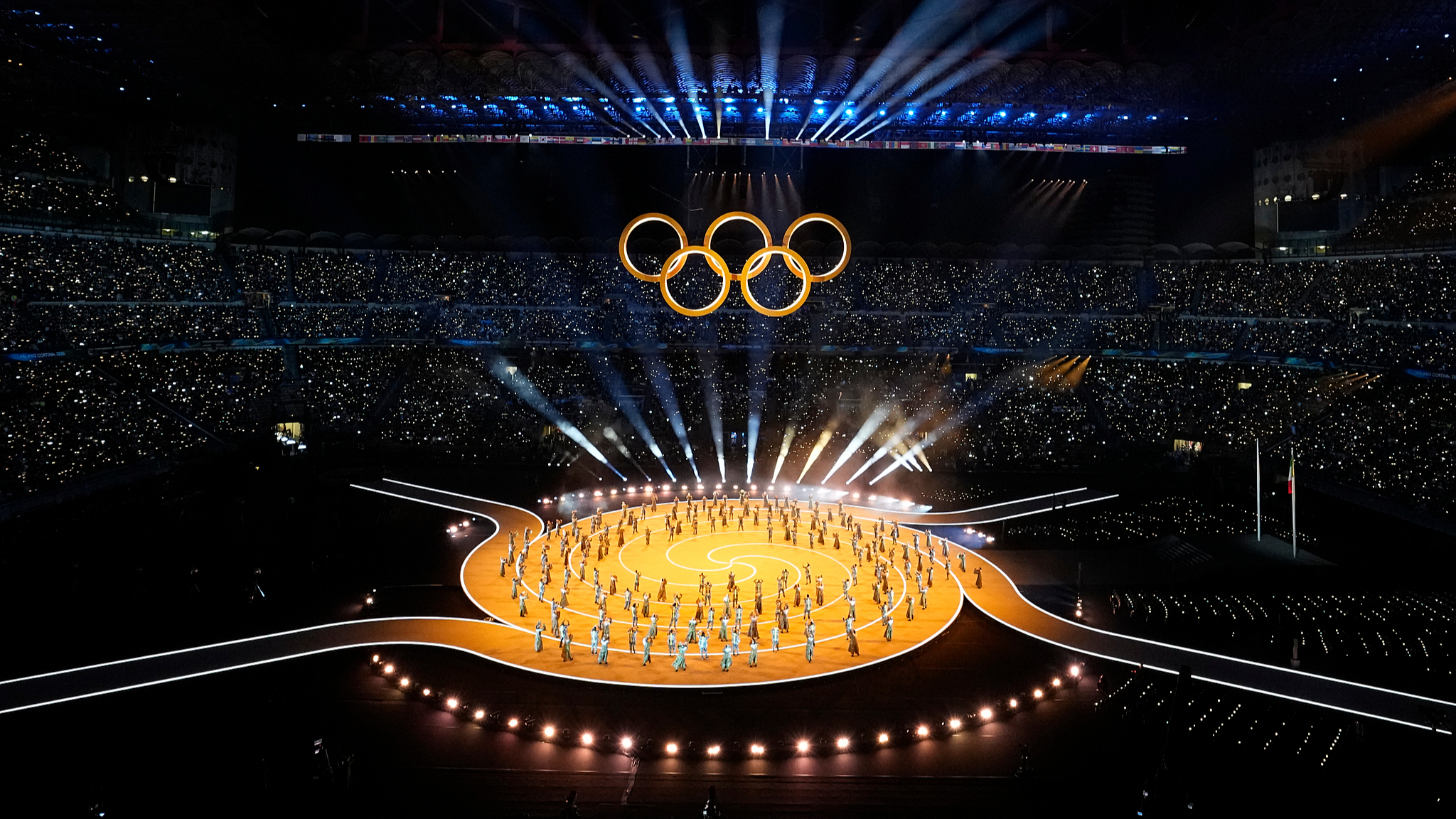 The Olympic rings are highlighted as part of a performance during the opening ceremony at the 2026 Milano Cortina Winter Olympics in Milan, Italy, February 6, 2026. /VCG