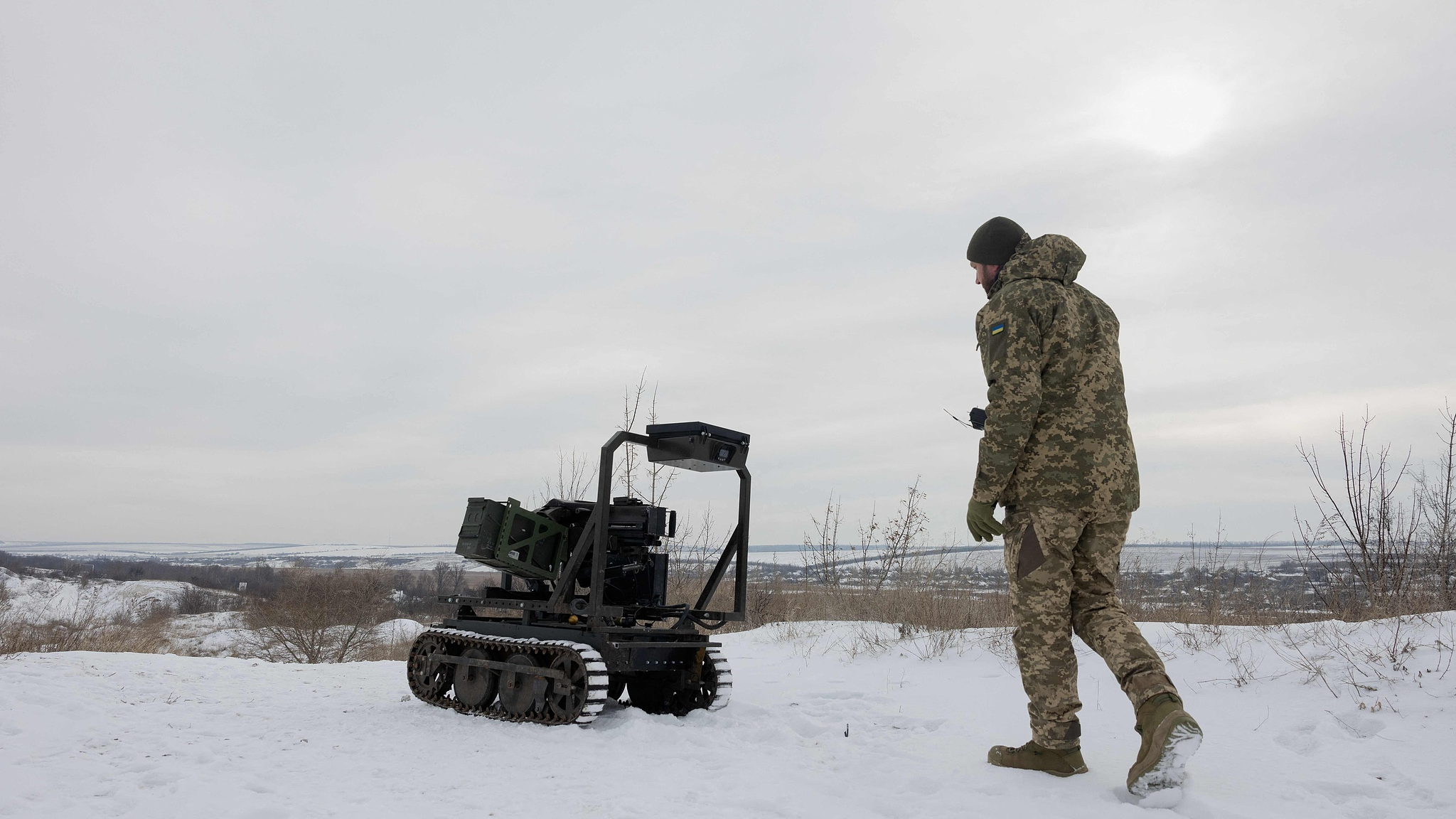 A Ukrainian serviceman of the 30th separate mechanized brigade prepares an unmanned robotic ground vehicle armed with an Mk 19 grenade launcher to test at an undisclosed location in the Donetsk region on January 27, 2026. /VCG