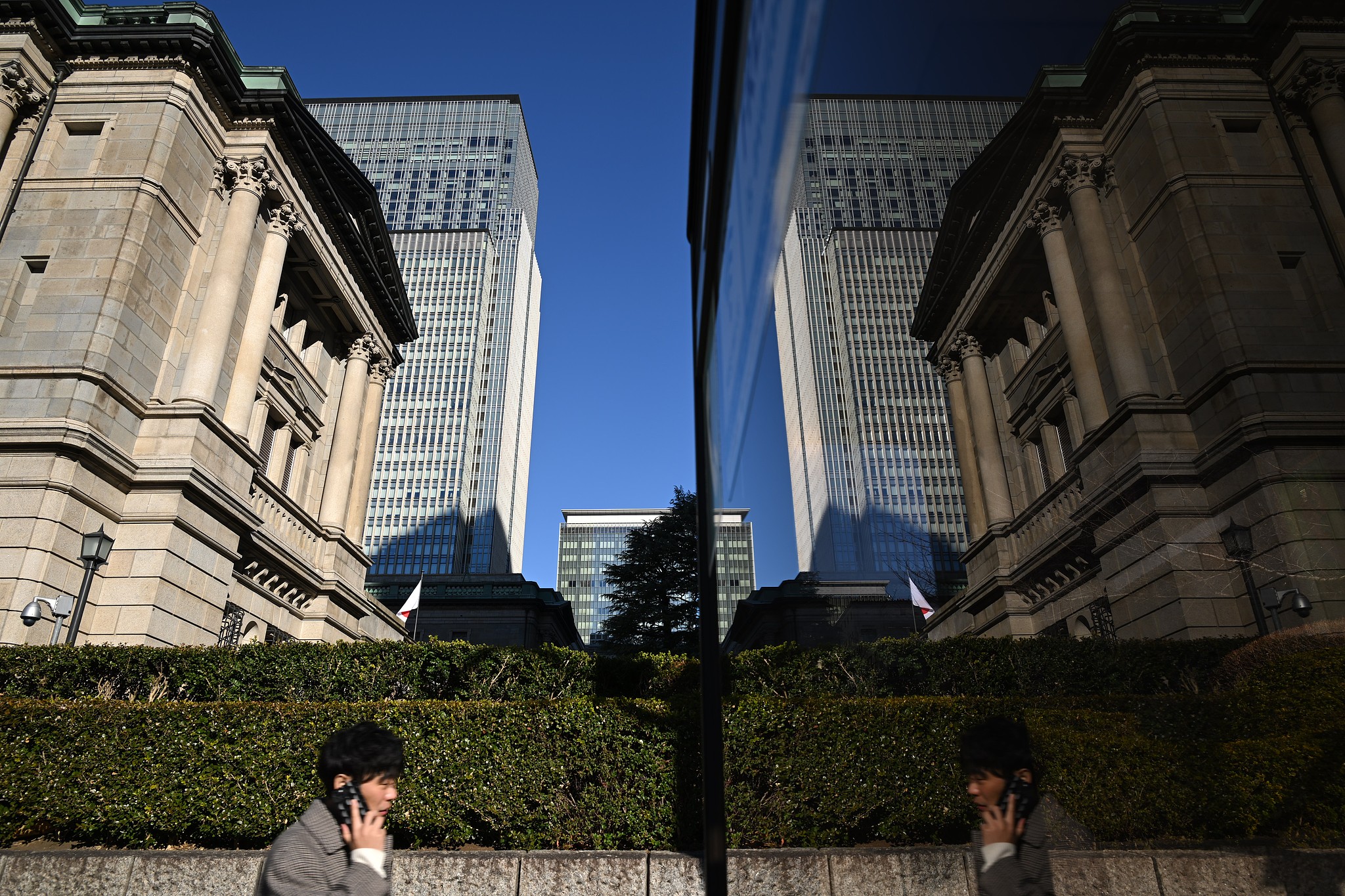 The Bank of Japan (BOJ) headquarters reflected on a telephone booth in Tokyo, Japan, January 23, 2026. /VCG