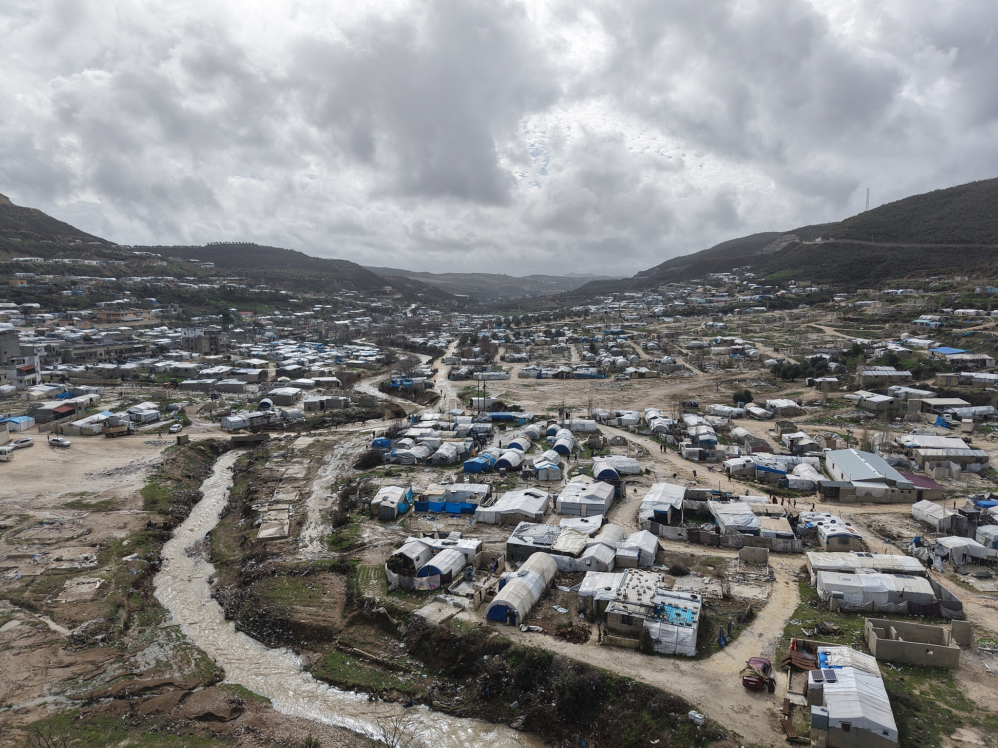 An aerial view shows the extent of damage in tent camps following heavy rainfall and flash floods in the Idlib province of northwestern Syria on February 8, 2026. /VCG