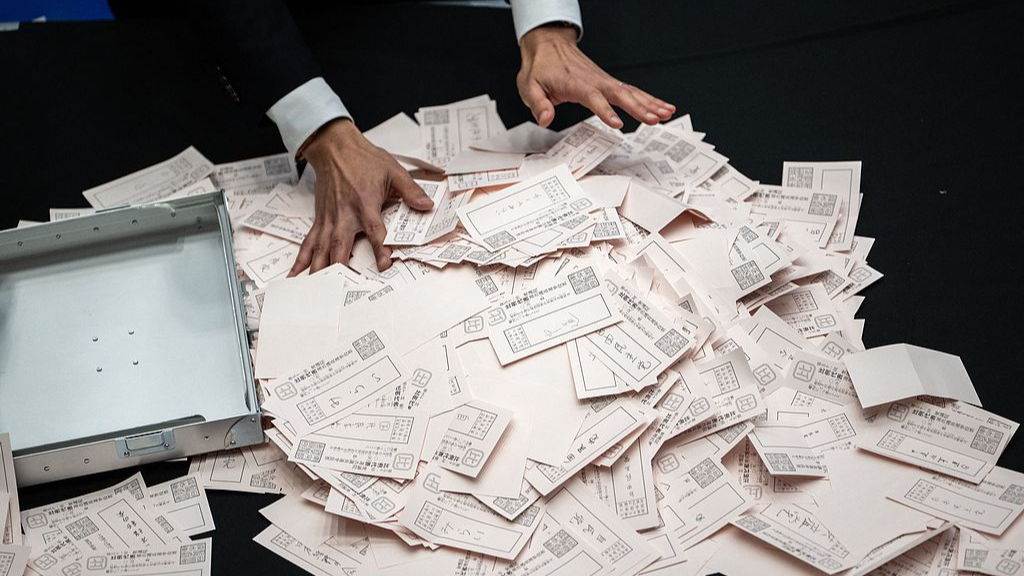 An official of the election administration committee counts the votes for the House of Representatives election in Minato Distict of Tokyo, Japan, February 8, 2026. /VCG