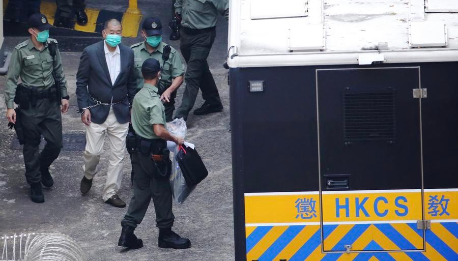 Media mogul Jimmy Lai is taken to the West Kowloon Magistrates' Courts in Hong Kong under police escort for trial, China, December 12, 2020. /Xinhua