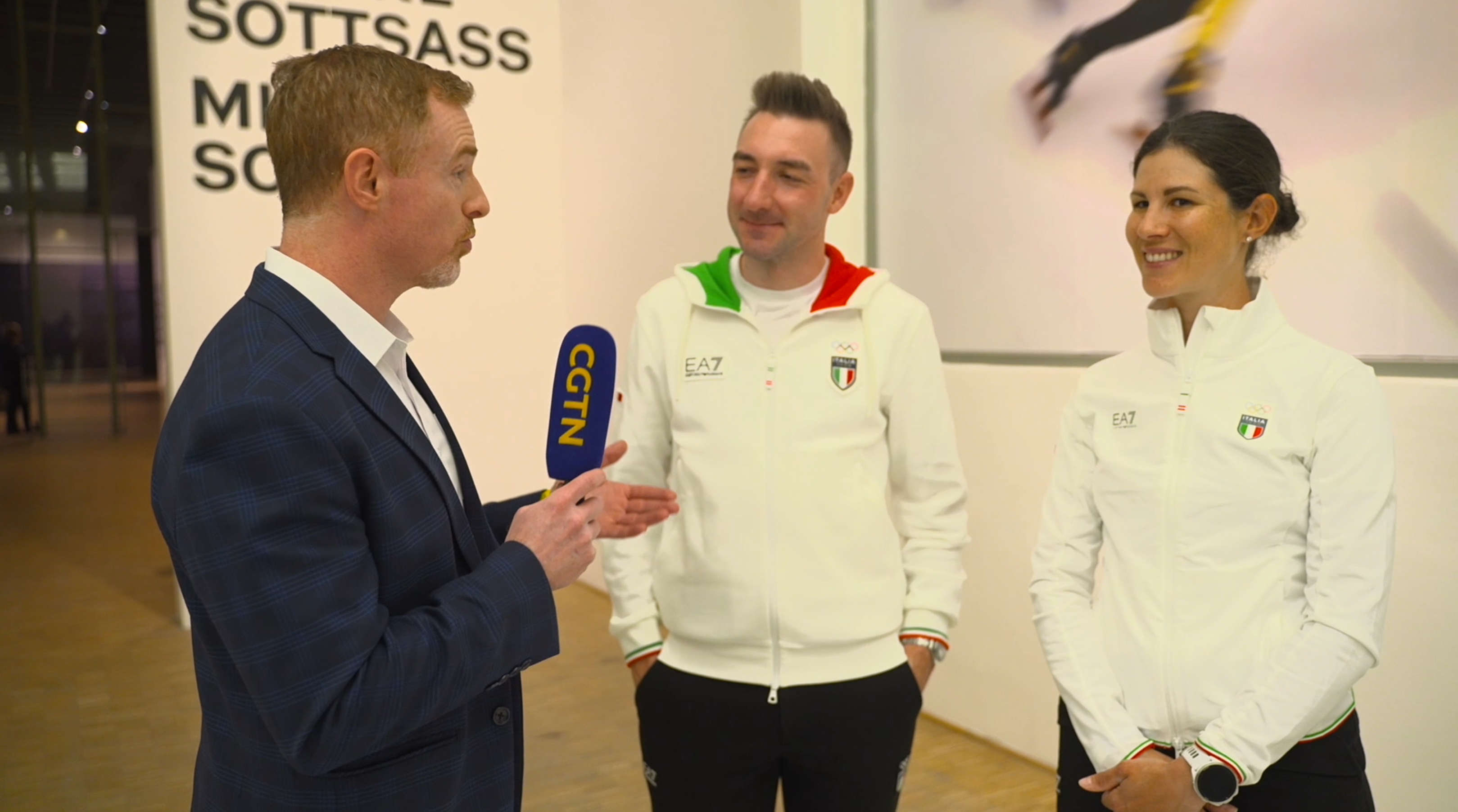 L-R: Greg Laffradi of CGTN Sports Scene, Team Italy ambassadors Elia Viviani and Elena Cecchini at Italy House duirng the 2026 Milano Cortina Winter Olympics in Milan, Italy. /CGTN