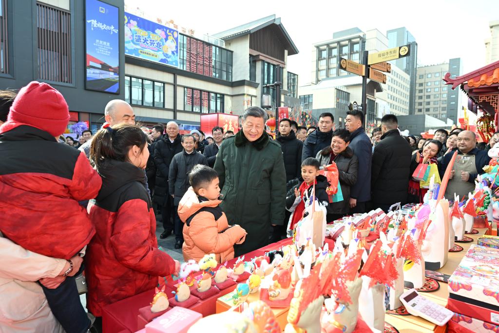 Chinese President Xi Jinping, also general secretary of the Communist Party of China Central Committee and chairman of the Central Military Commission, talks with people while visiting a Spring Festival market at the Longfusi commercial area in Dongcheng District of Beijing, capital of China, February 10, 2026. Xi visited primary-level officials and residents in Beijing during a two-day inspection tour from Monday to Tuesday. /Xinhua