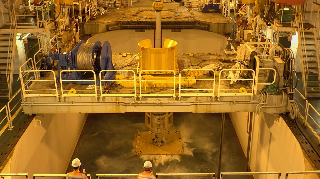 A mining device lowers to the seabed from the deep-sea drilling vessel Chikyu, off Minamitorishima, south of Tokyo, January 18, 2026.