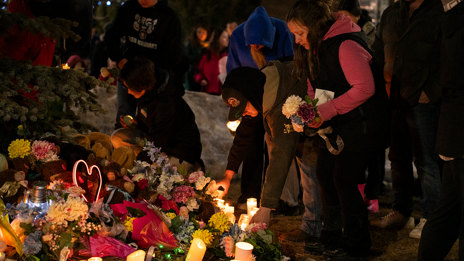 Community members place flowers at a memorial during a candlelight vigil for the victims of Tumbler Ridge Secondary School where a mass shooting took place a day earlier, in the small town of Tumbler Ridge, British Columbia, February 11, 2026. /VCG