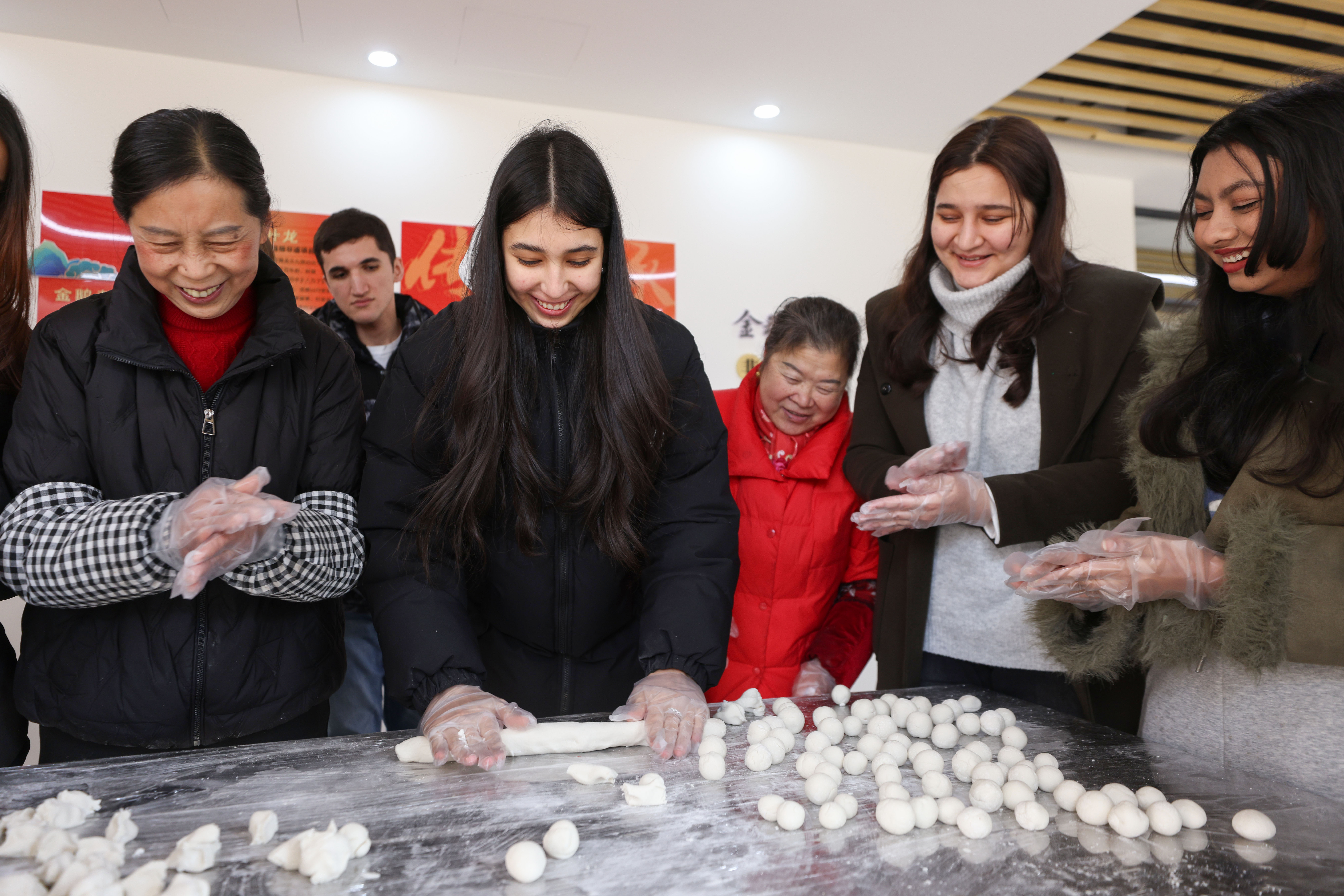 Foreign students gather to make glutinous rice balls, bonding over the festive culinary tradition in Deqing, Zhejiang Province on February 8, 2026. /Zhao Ning