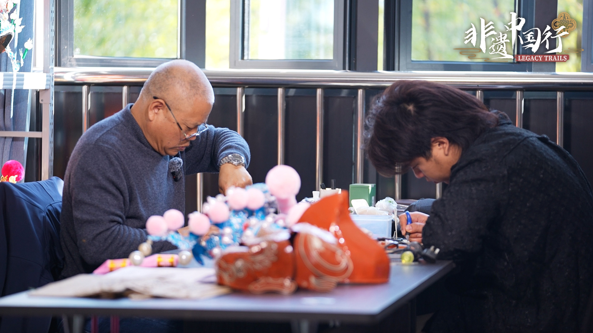 Master craftsman Mei Lizhong and his son make Wu Opera headpieces in the workshop at the Yiwu Wu Opera Heritage and Protection Center.