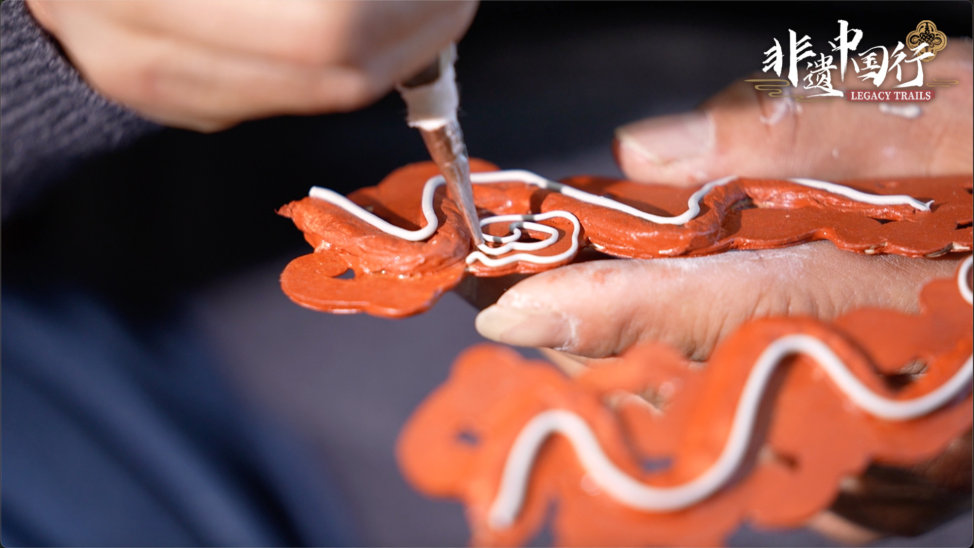 Master craftsman Mei Lizhong applies filigree powder on one piece of a Wu Opera headpiece.