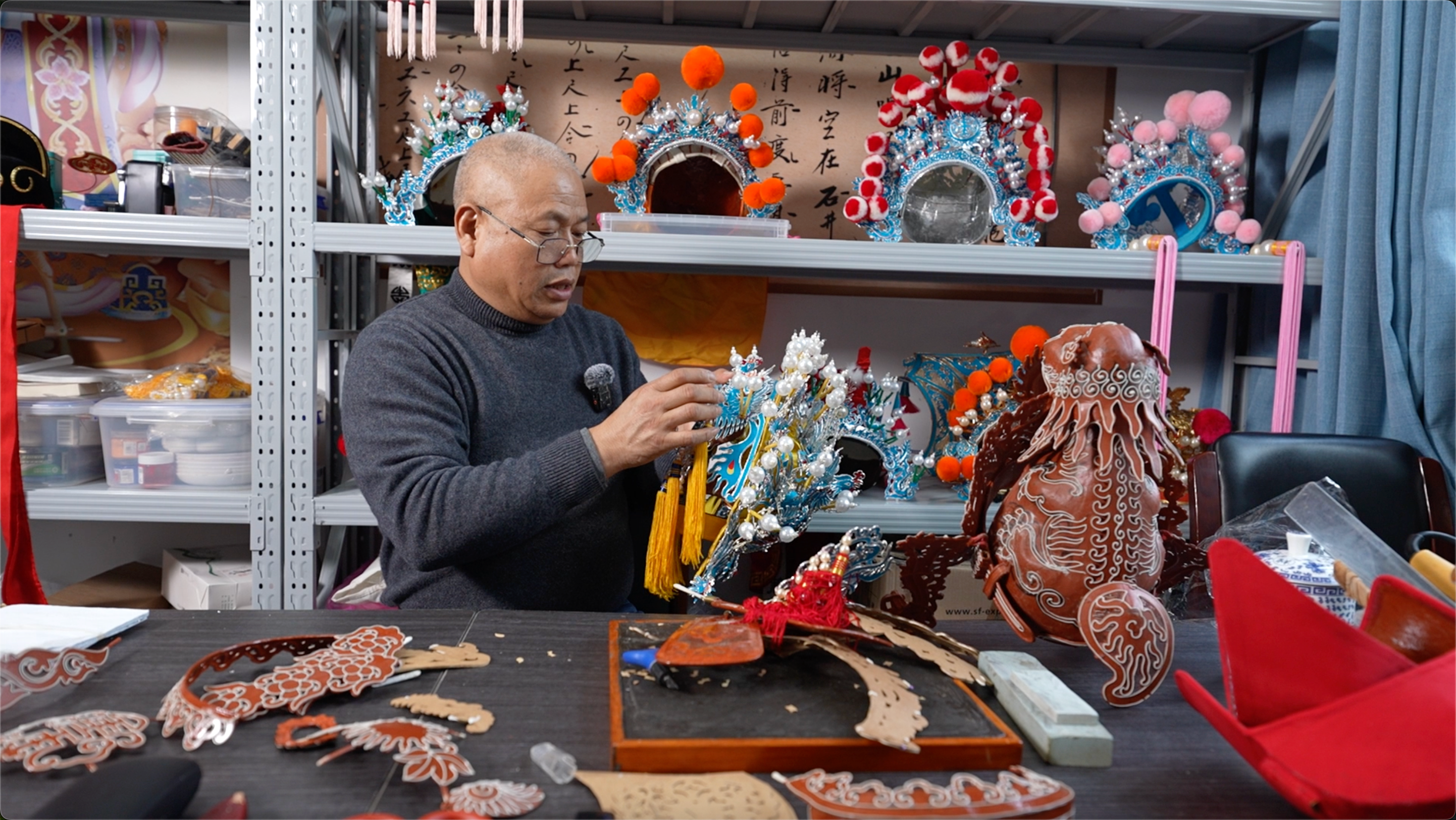Master craftsman Mei Lizhong shows a Wu Opera headpiece in his workshop at the Yiwu Wu Opera Heritage and Protection Center.