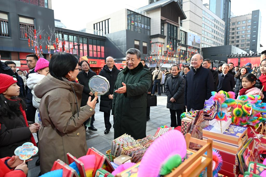 Chinese President Xi Jinping talks with people while visiting a Spring Festival market at the Longfusi commercial area in Dongcheng District of Beijing, capital of China, February 10, 2026. /Xinhua