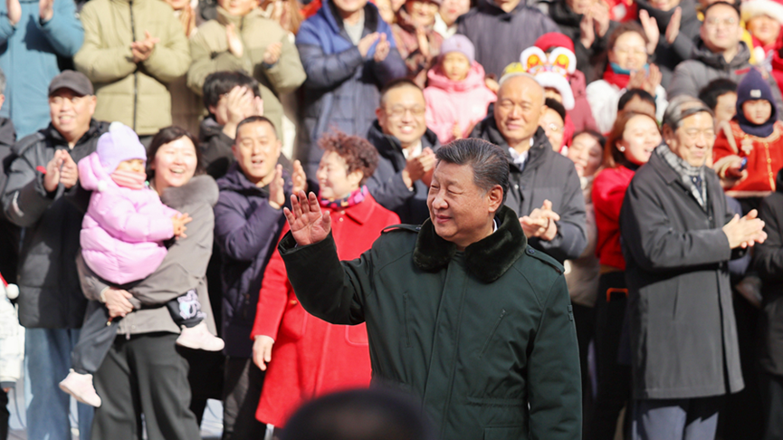 Chinese President Xi Jinping, also general secretary of the Communist Party of China Central Committee and chairman of the Central Military Commission, waves hands to people at Longfusi commercial area in Dongcheng District, Beijing, capital of China, February 10, 2026. /Xinhua