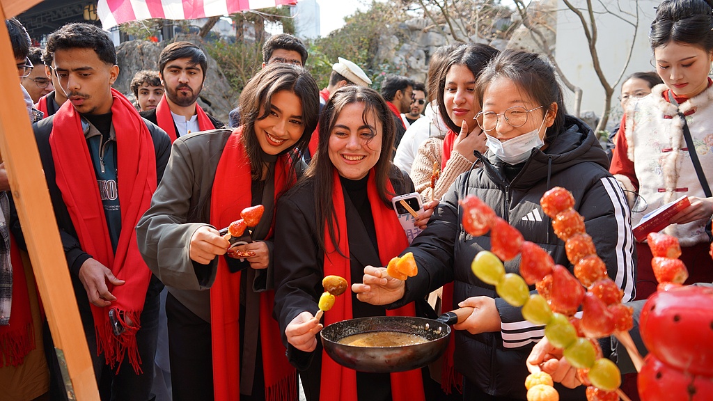 Foreign visitors take part in Spring Festival folk culture activities, experiencing traditional Chinese New Year customs, Shiyan City, central China's Hubei Province, February 9, 2026. /VCG