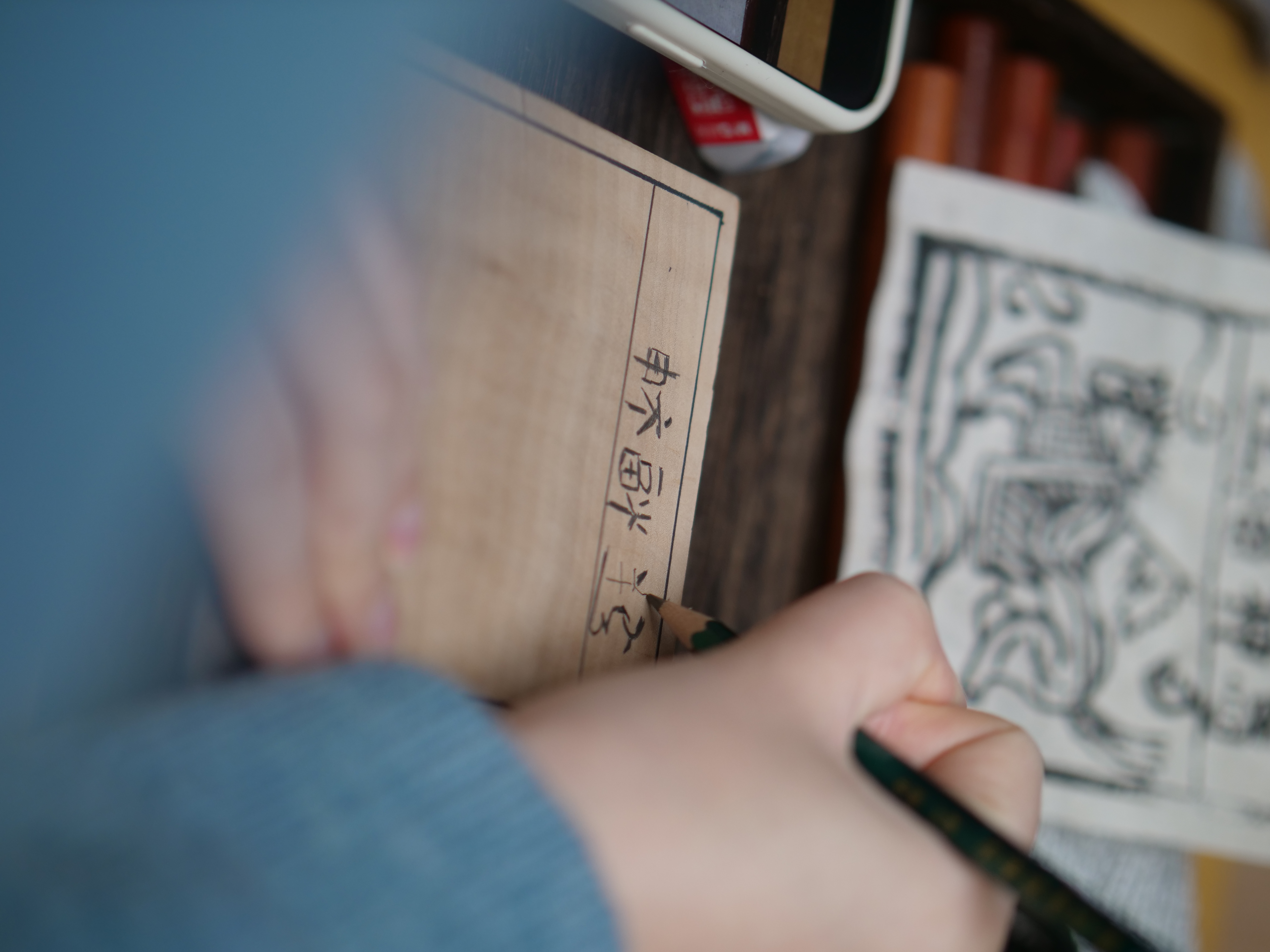 The first step in making a Jiama print is sketching the desired design onto a wooden block. /CGTN