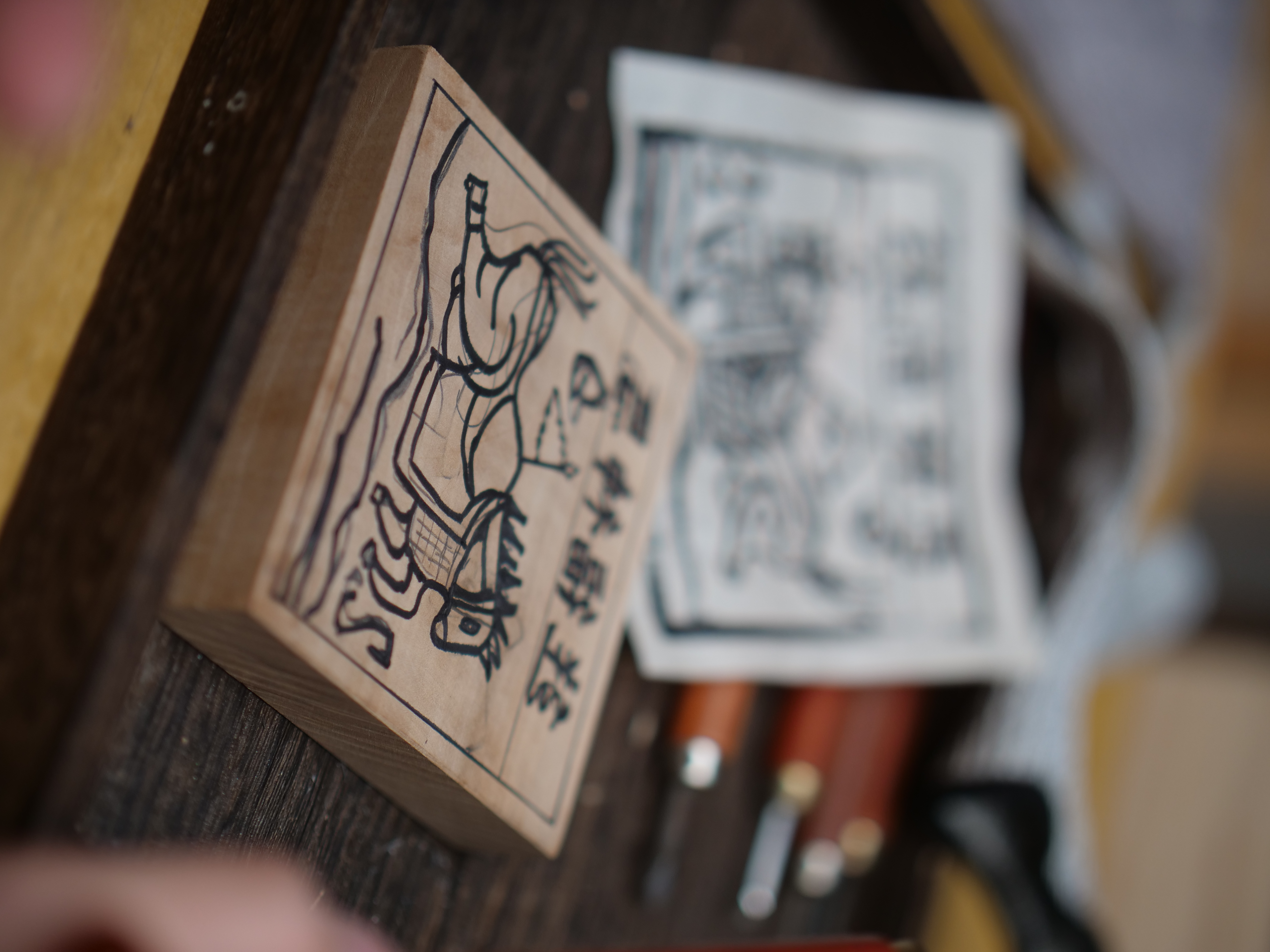 The first step in making a Jiama print is sketching the desired design onto a wooden block. /CGTN