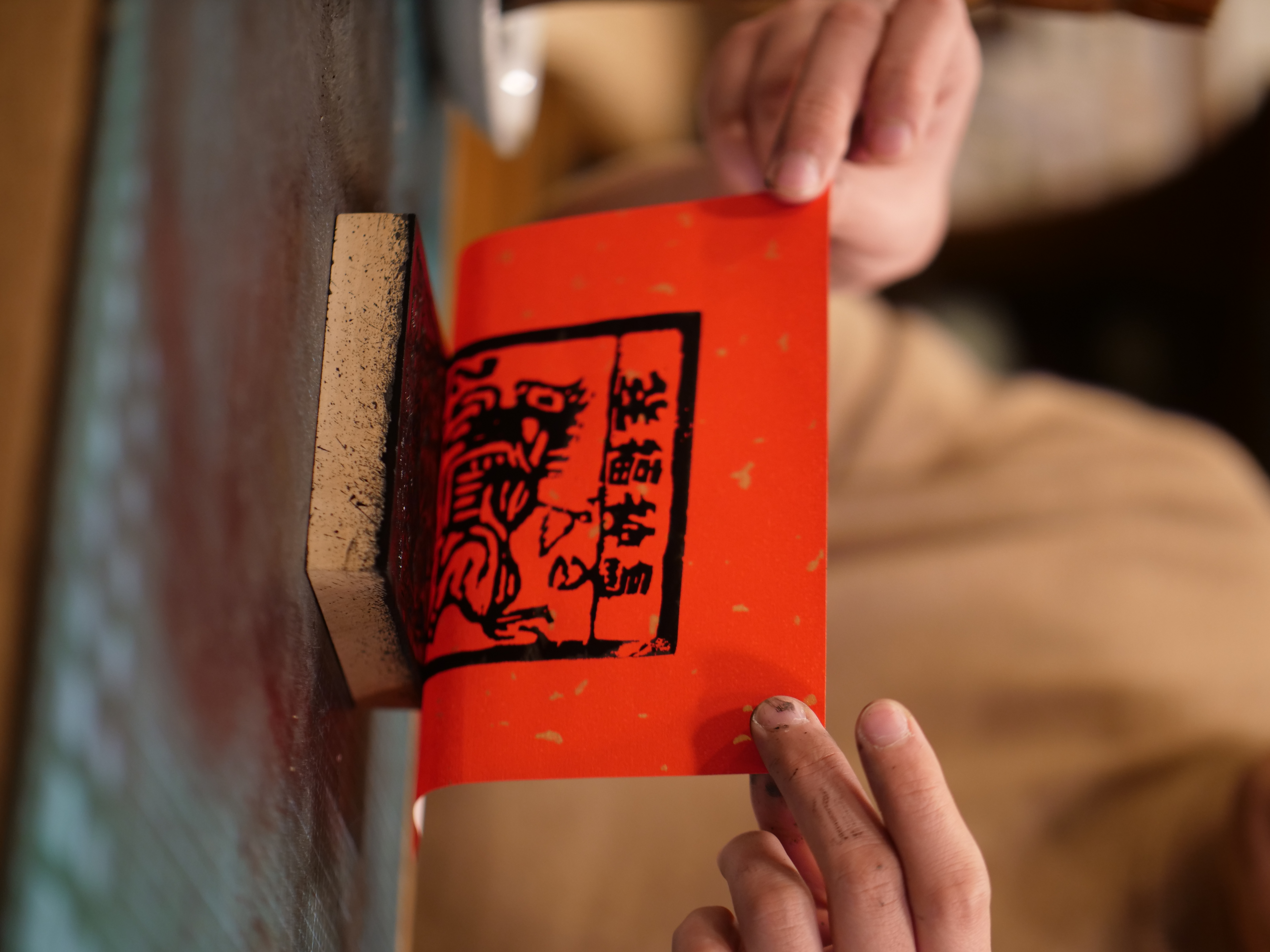 Ink is then applied to the wooden block and pressed onto paper to print the desired image. /CGTN