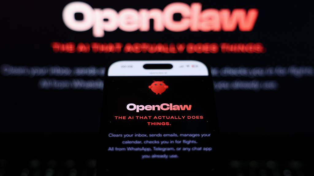 OpenClaw website on a laptop screen and on a phone screen. /VCG