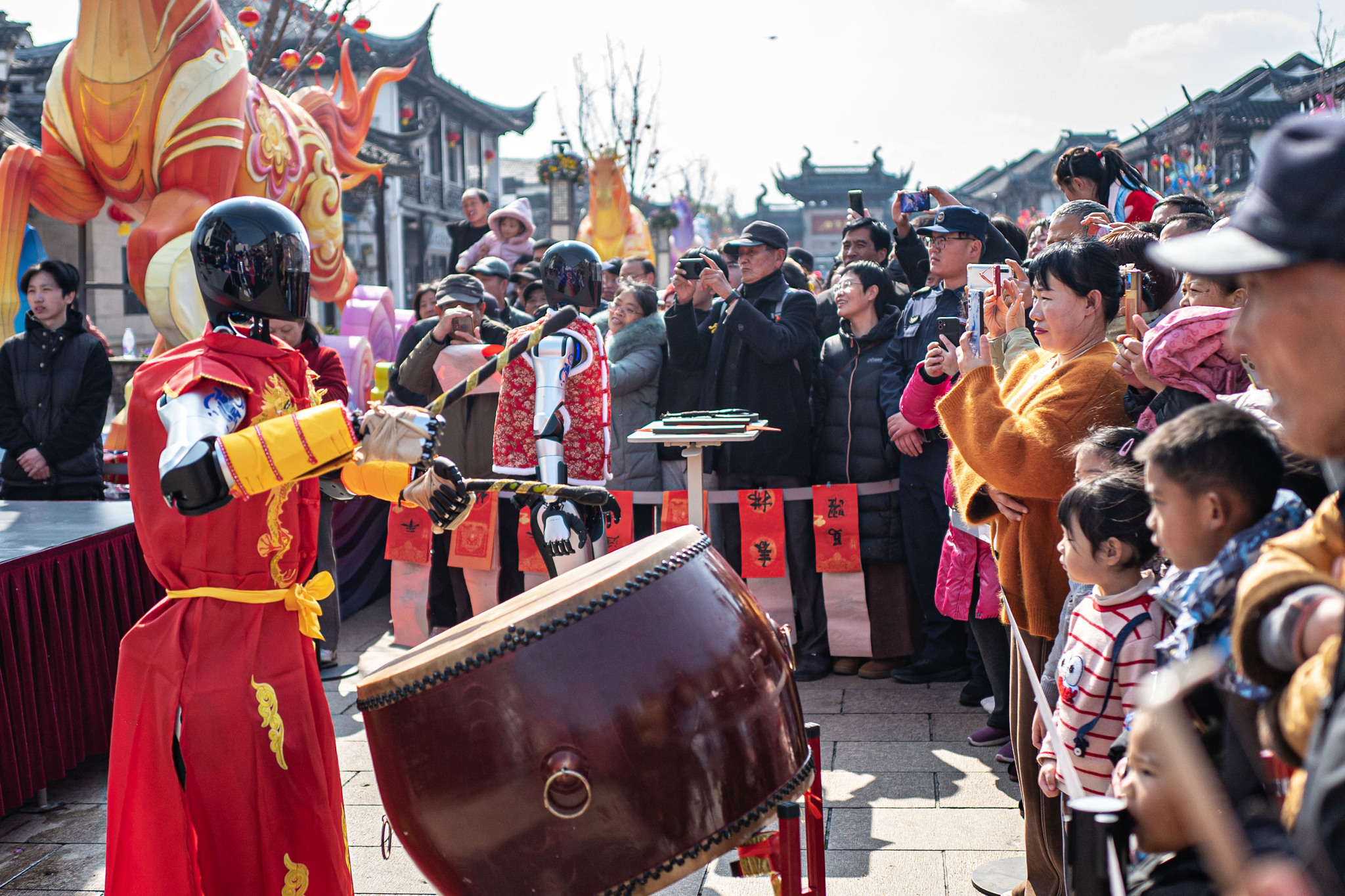 Humanoid robots beat drums at the ancient town of Zhouzhuang in Kunshan, east China's Jiangsu Province, on February 17, 2026. /VCG